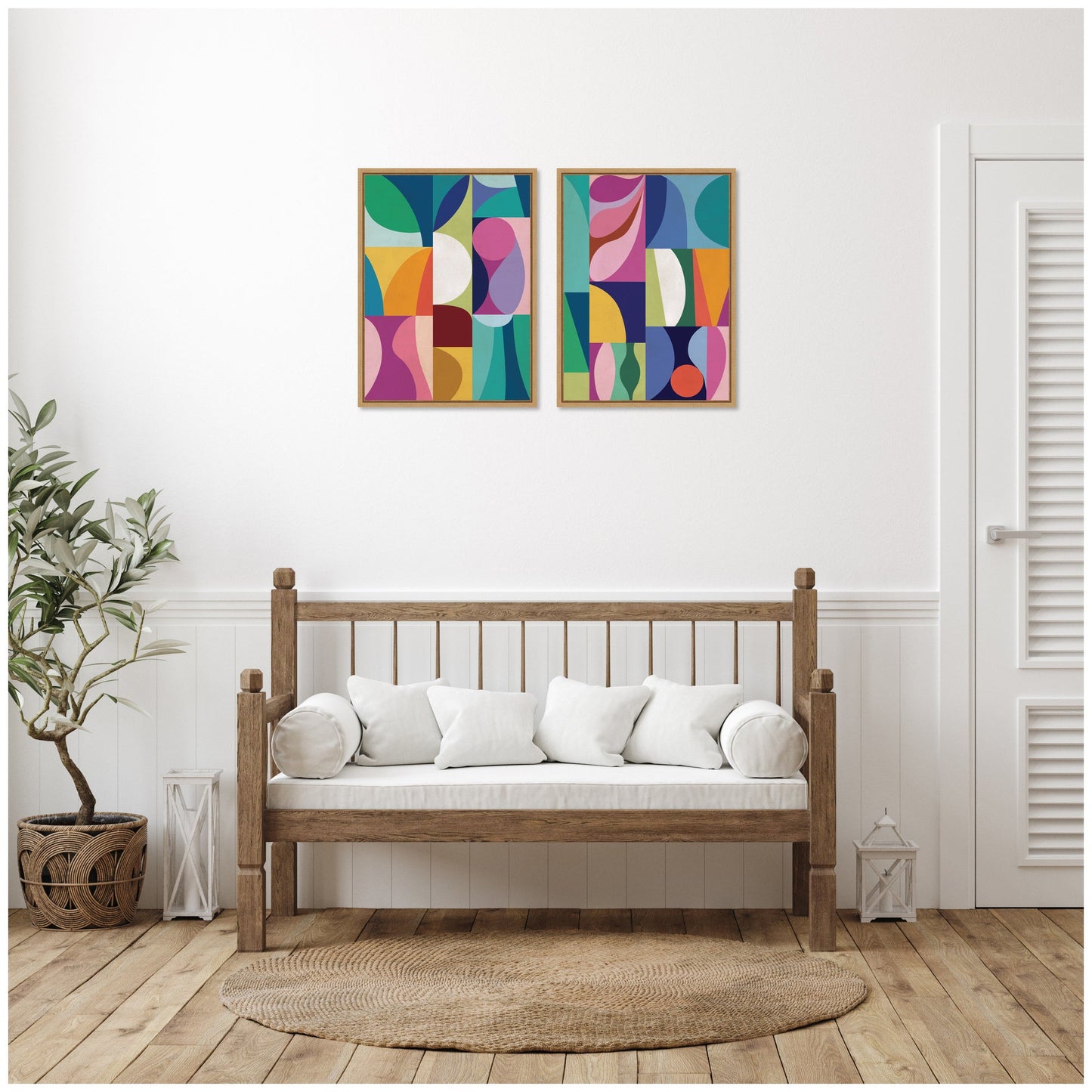 Wooden bench with white cushions in a room with abstract art on the wall.