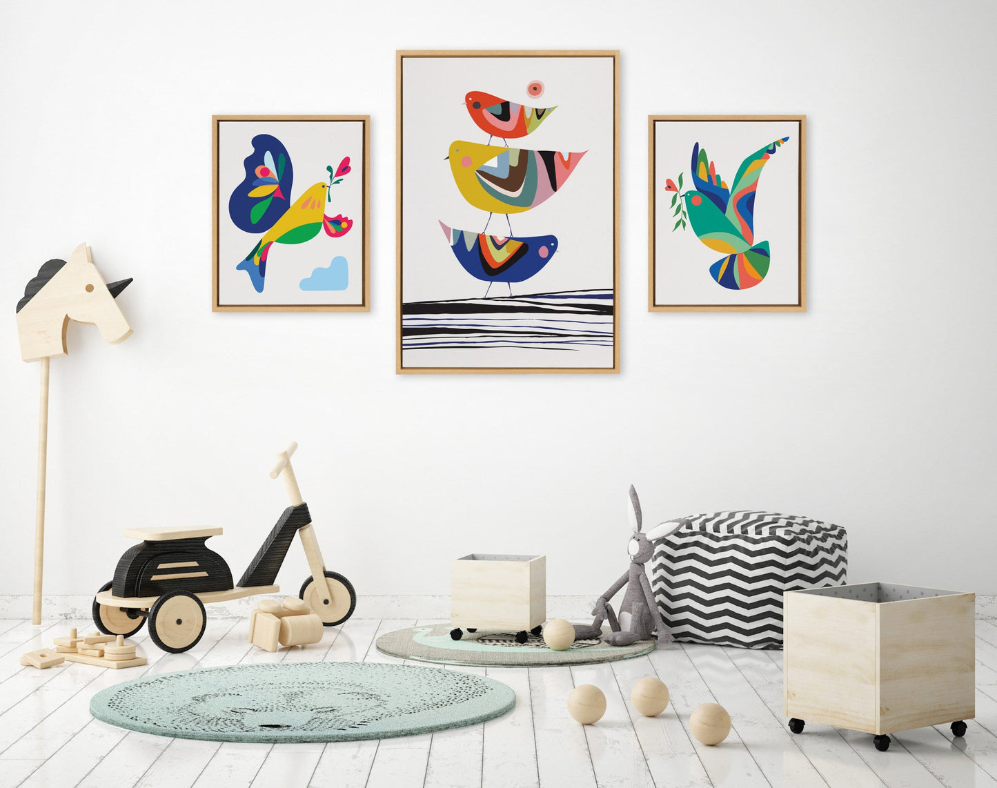 Children's room with colorful wall art, toys, and furniture on a white floor.