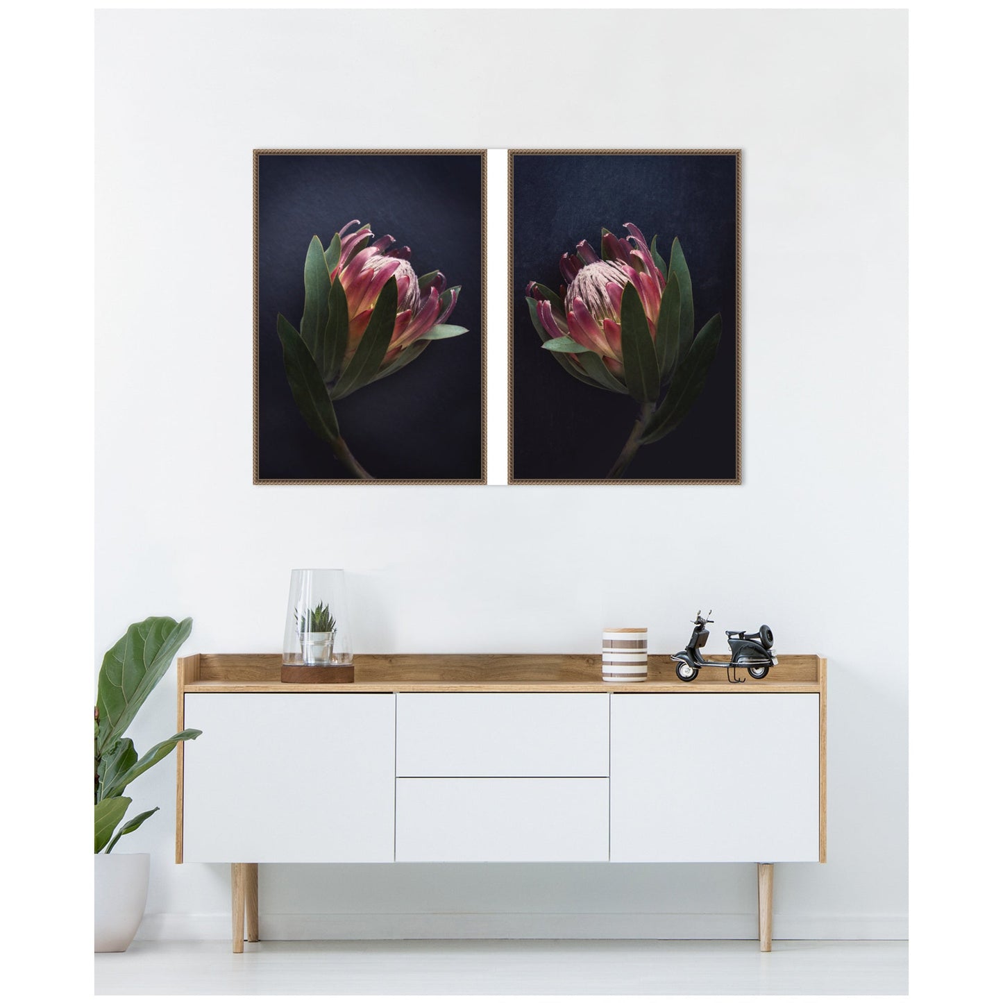 Two framed floral prints above a white console table with wooden top.