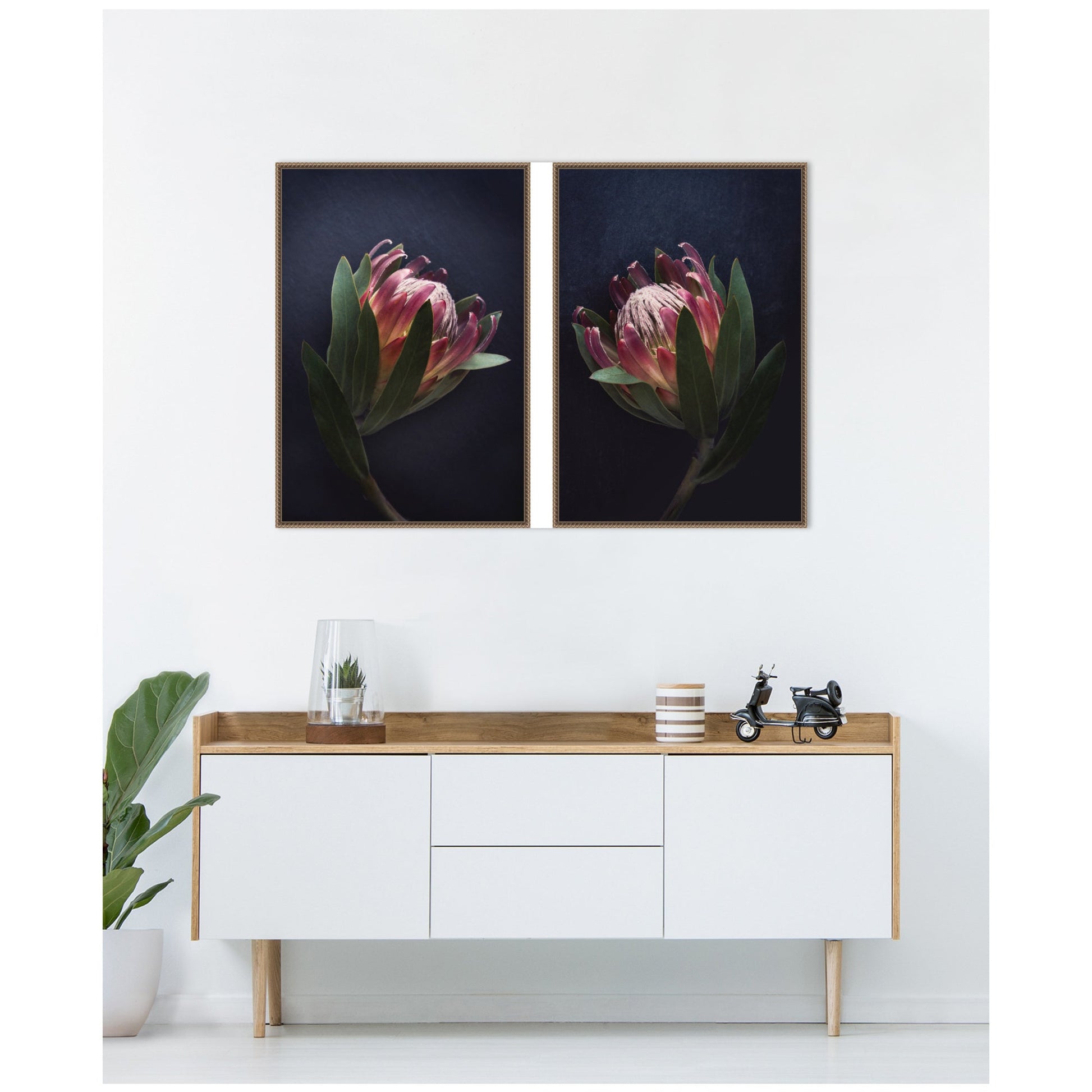 Two framed floral prints above a white console table with wooden top.