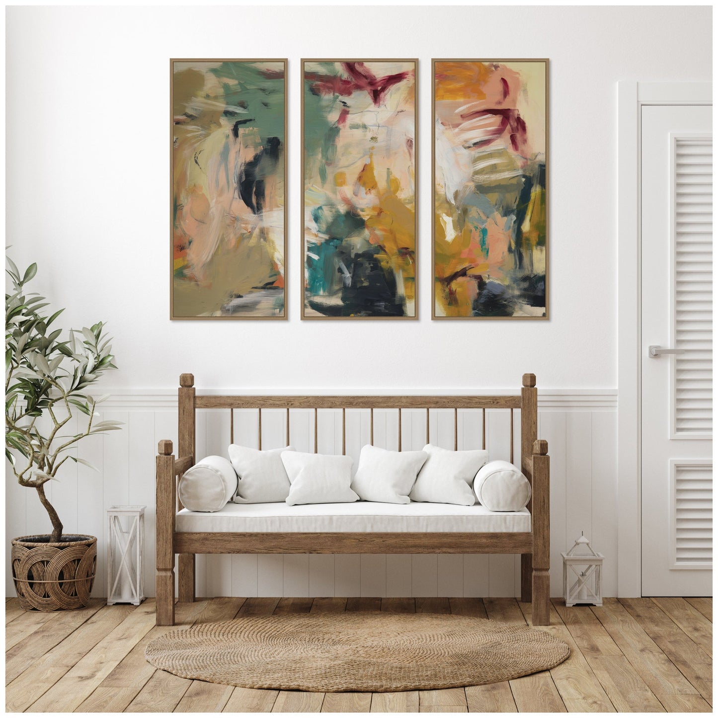 Wooden bench with white cushions in a room with abstract wall art