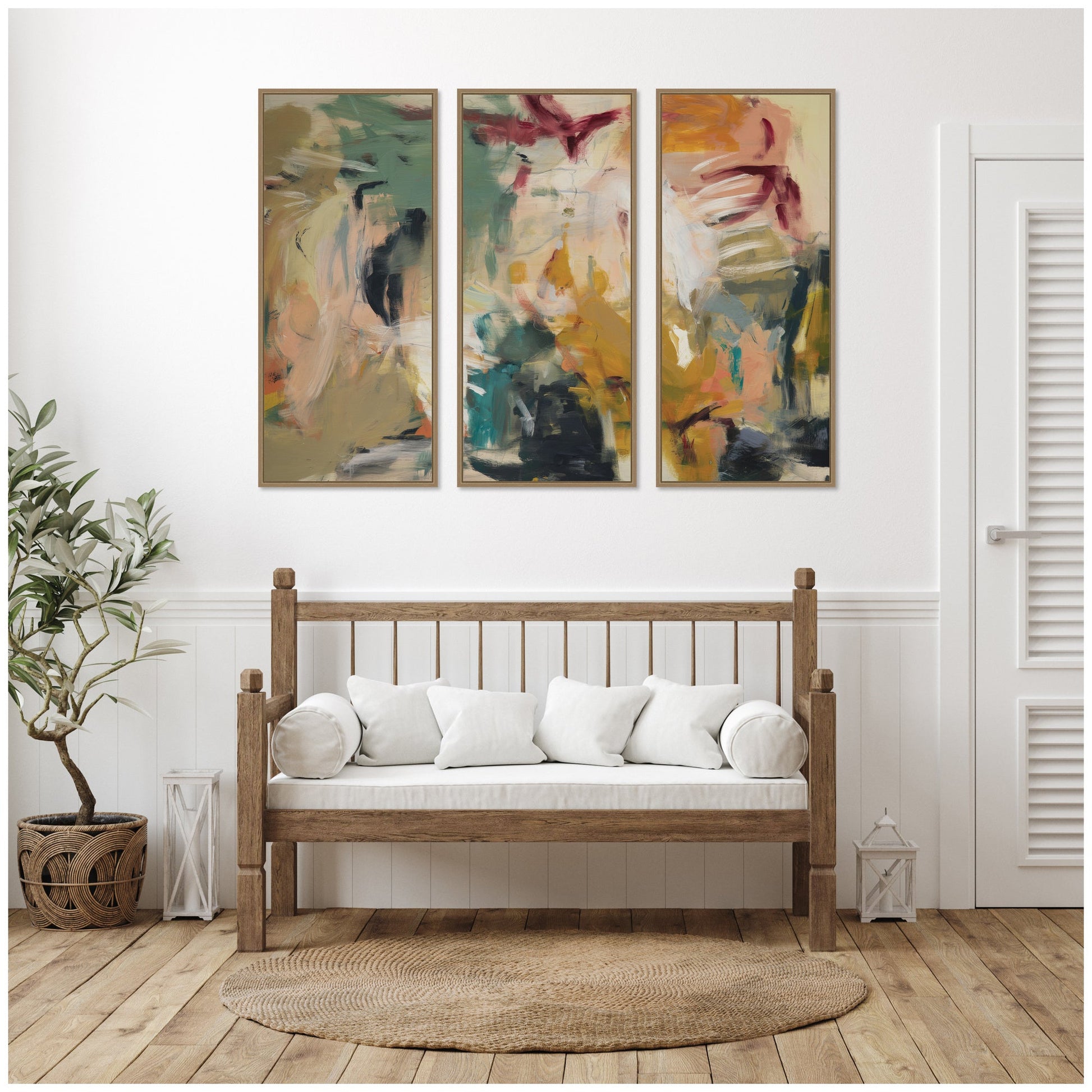 Wooden bench with white cushions in a room with abstract wall art