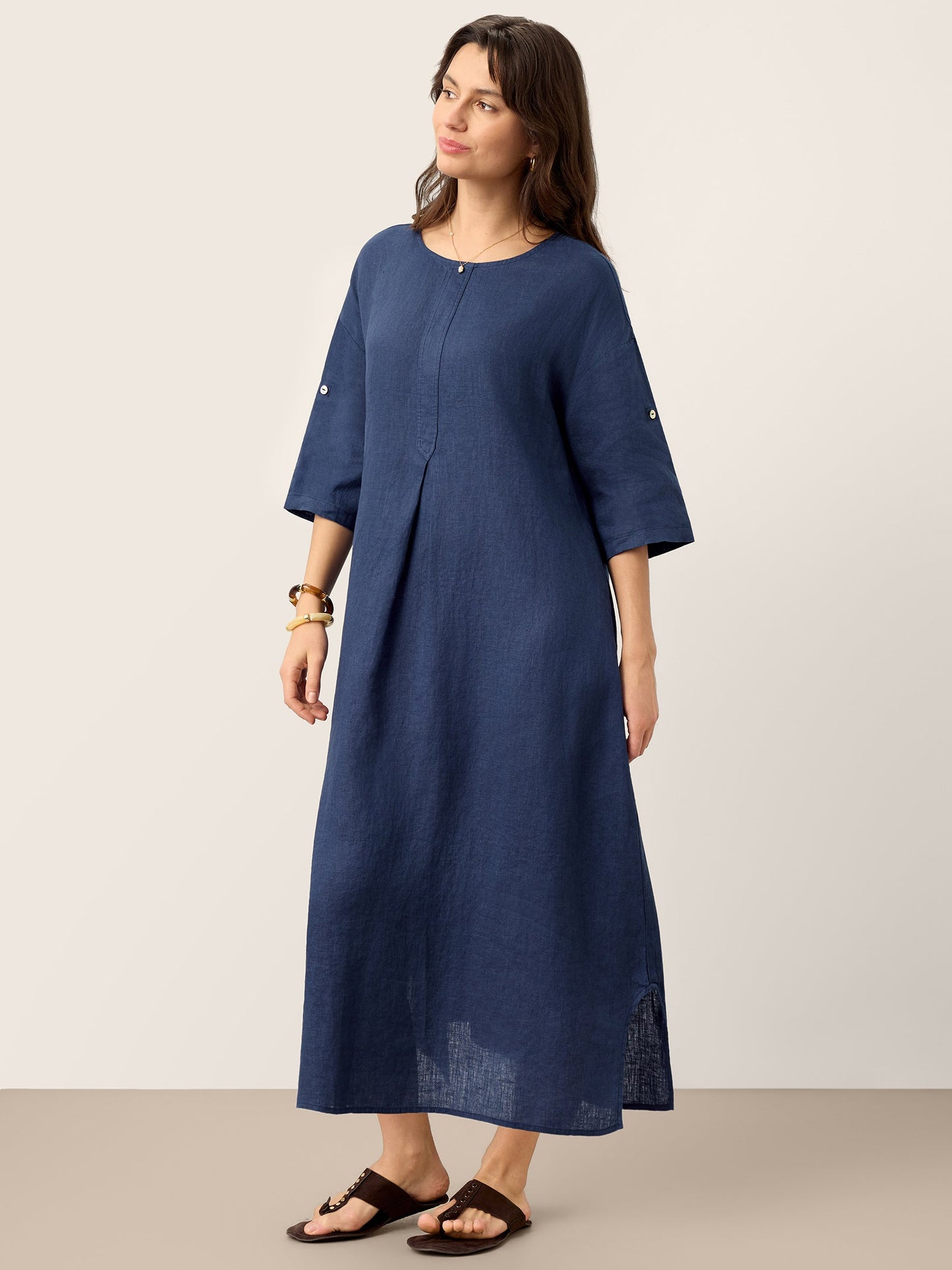 Woman wearing a blue dress against a plain background
