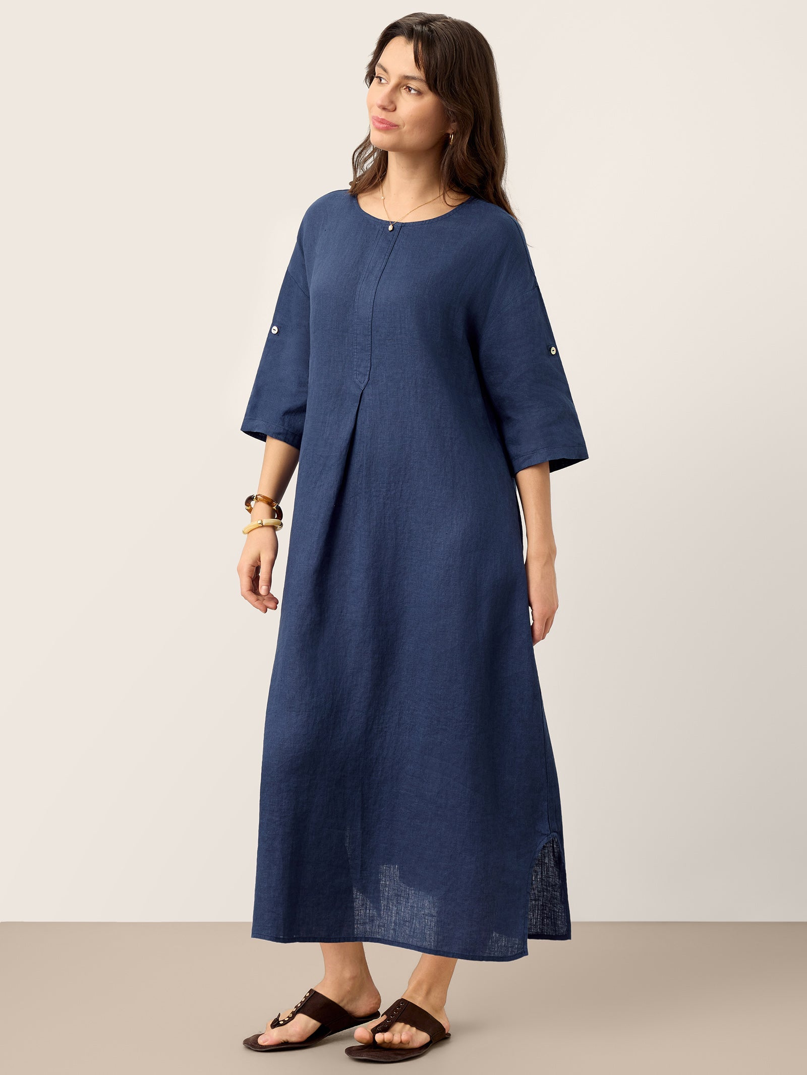 Woman wearing a blue dress against a plain background