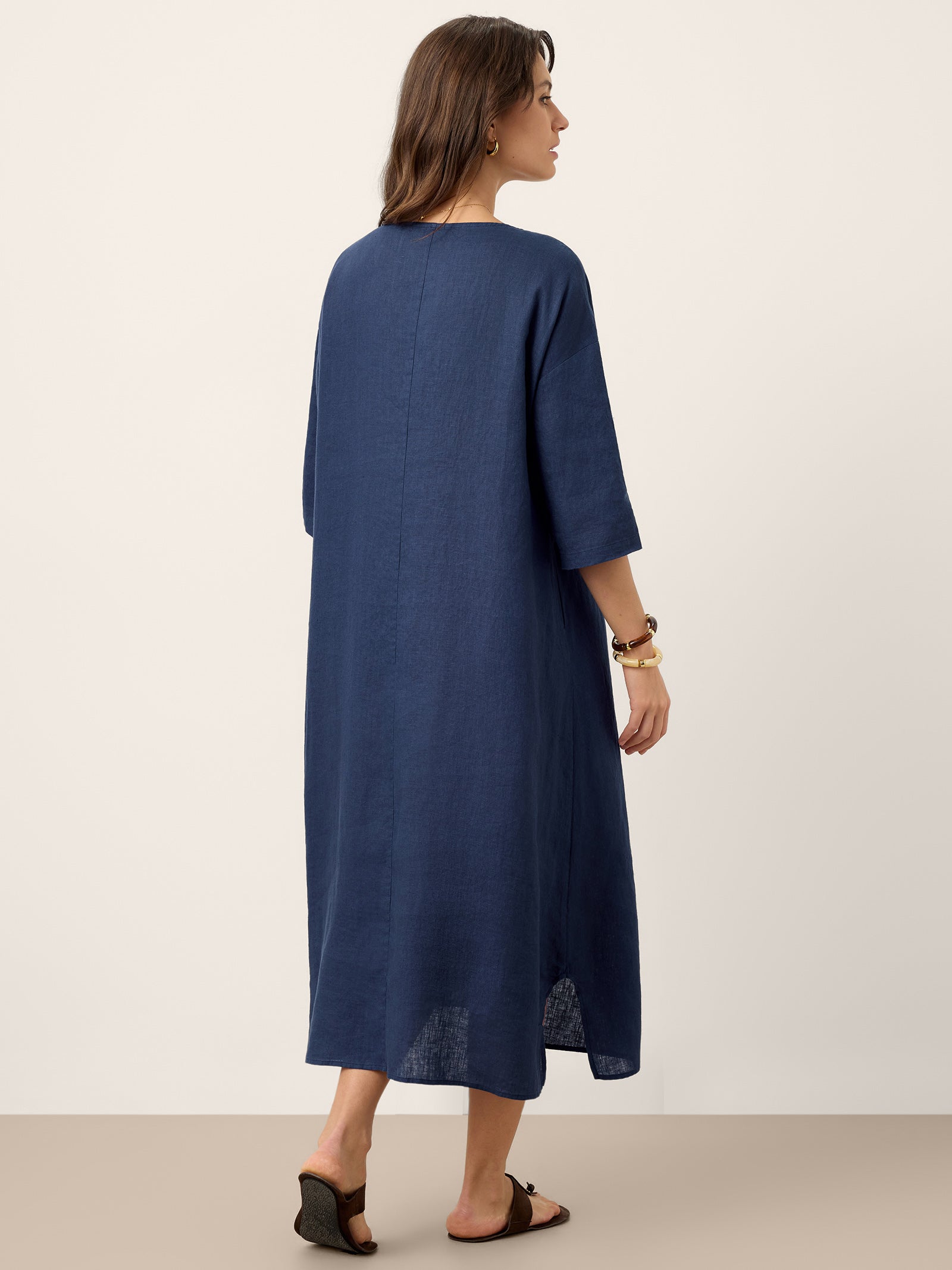 Woman wearing a blue dress against a white background