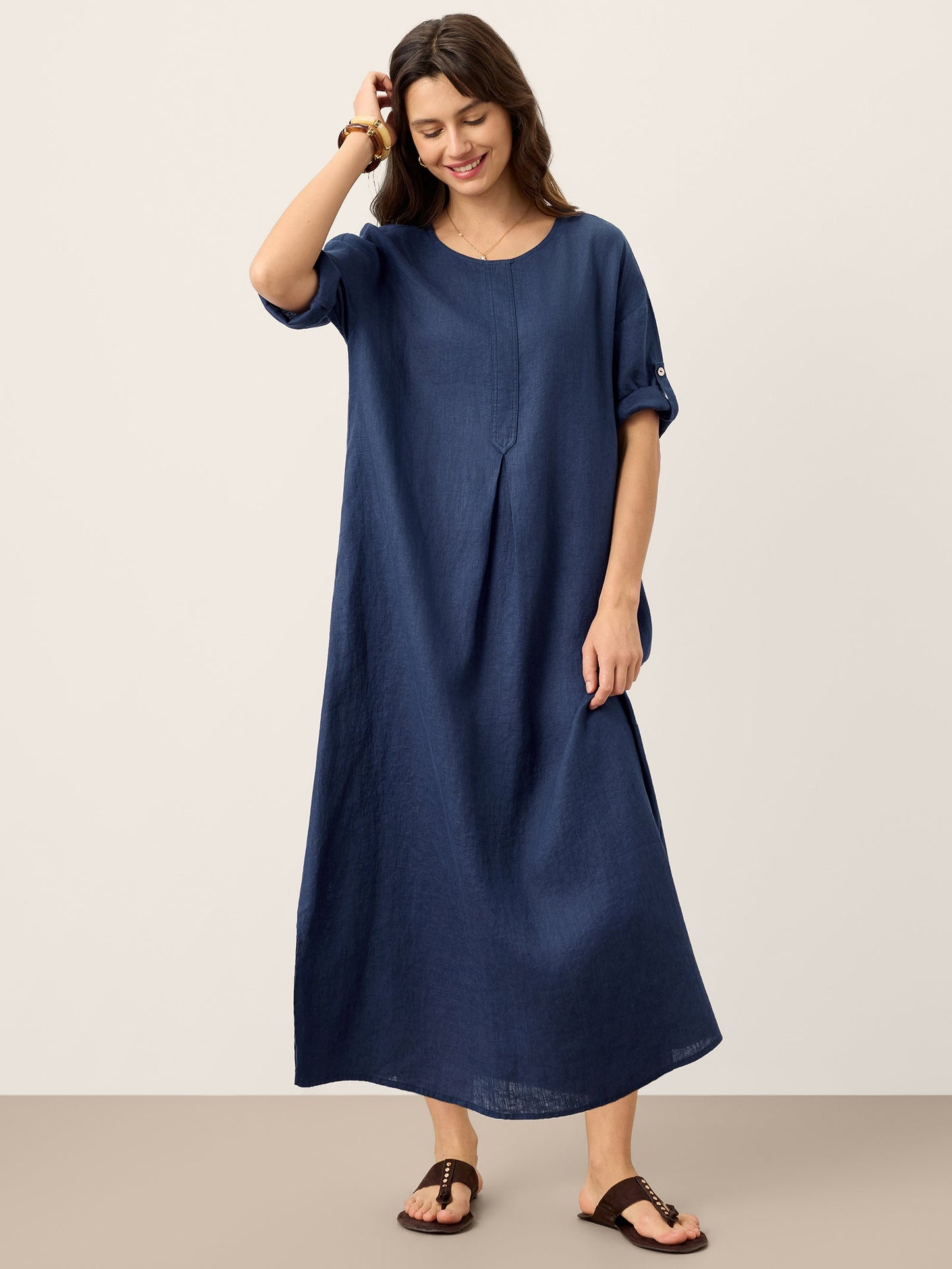 Woman wearing a blue dress against a plain background