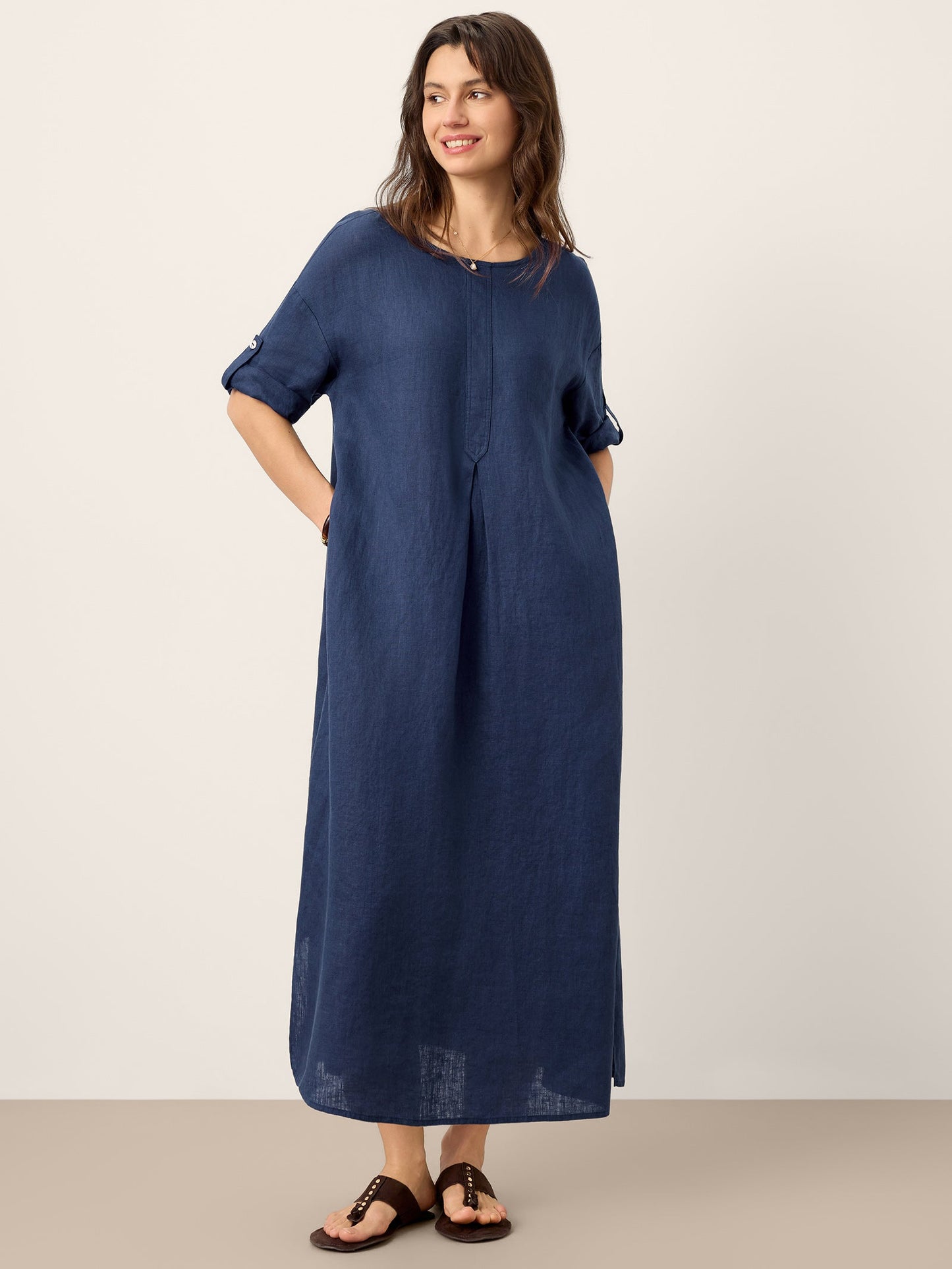 Woman wearing a blue dress against a white background