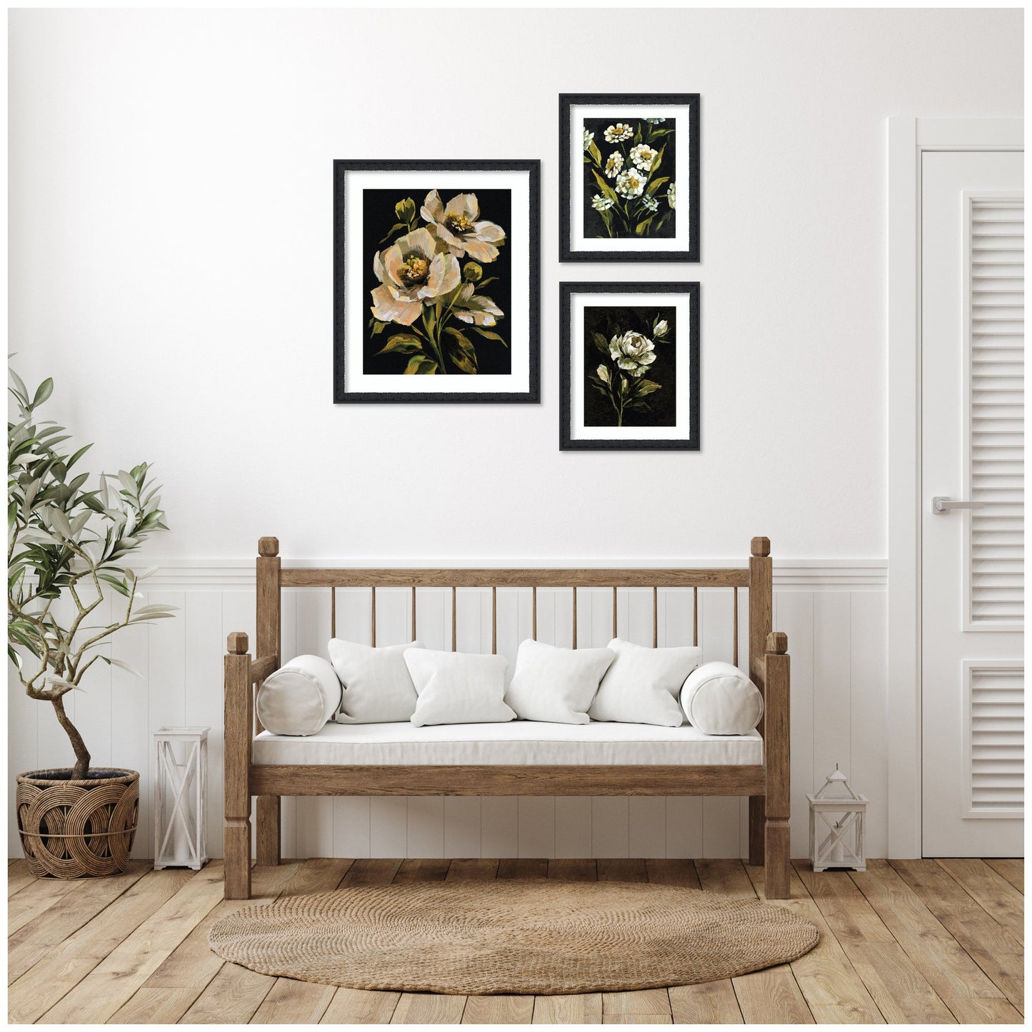 Wooden bench with white cushions in a room with floral wall art and a plant.