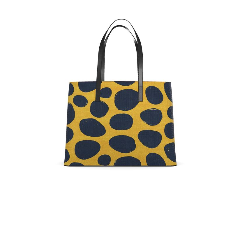 Tote bag with black polka dot pattern on a yellow background