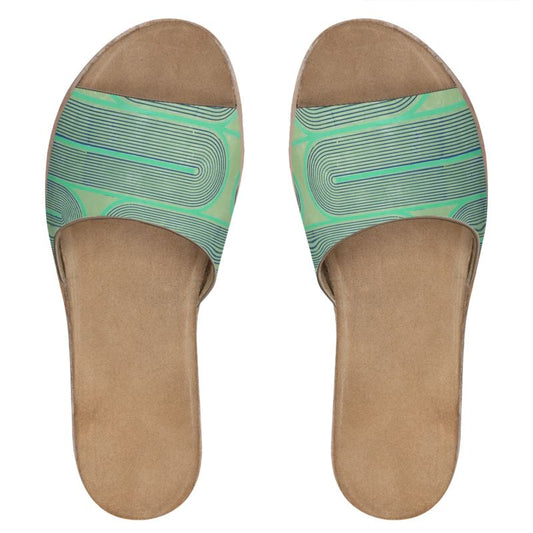 Pair of tan sandals with green patterned straps on a white background