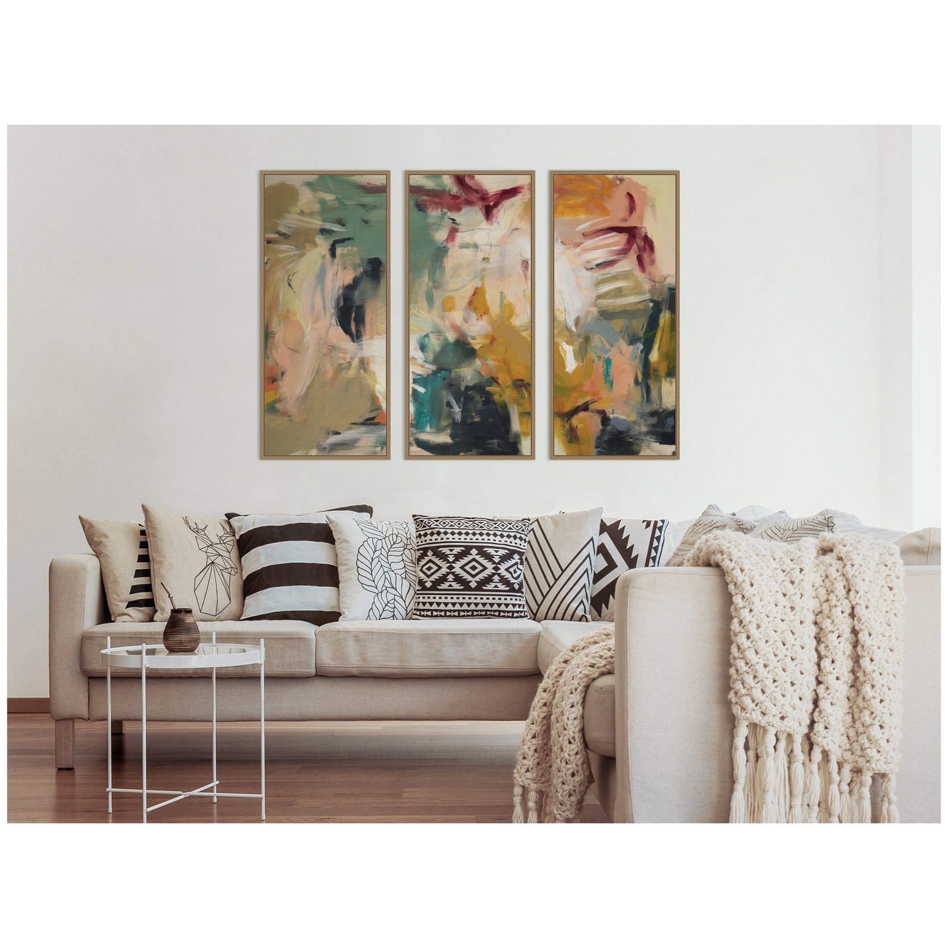 Sofa with decorative pillows and a blanket, featuring abstract art on the wall.