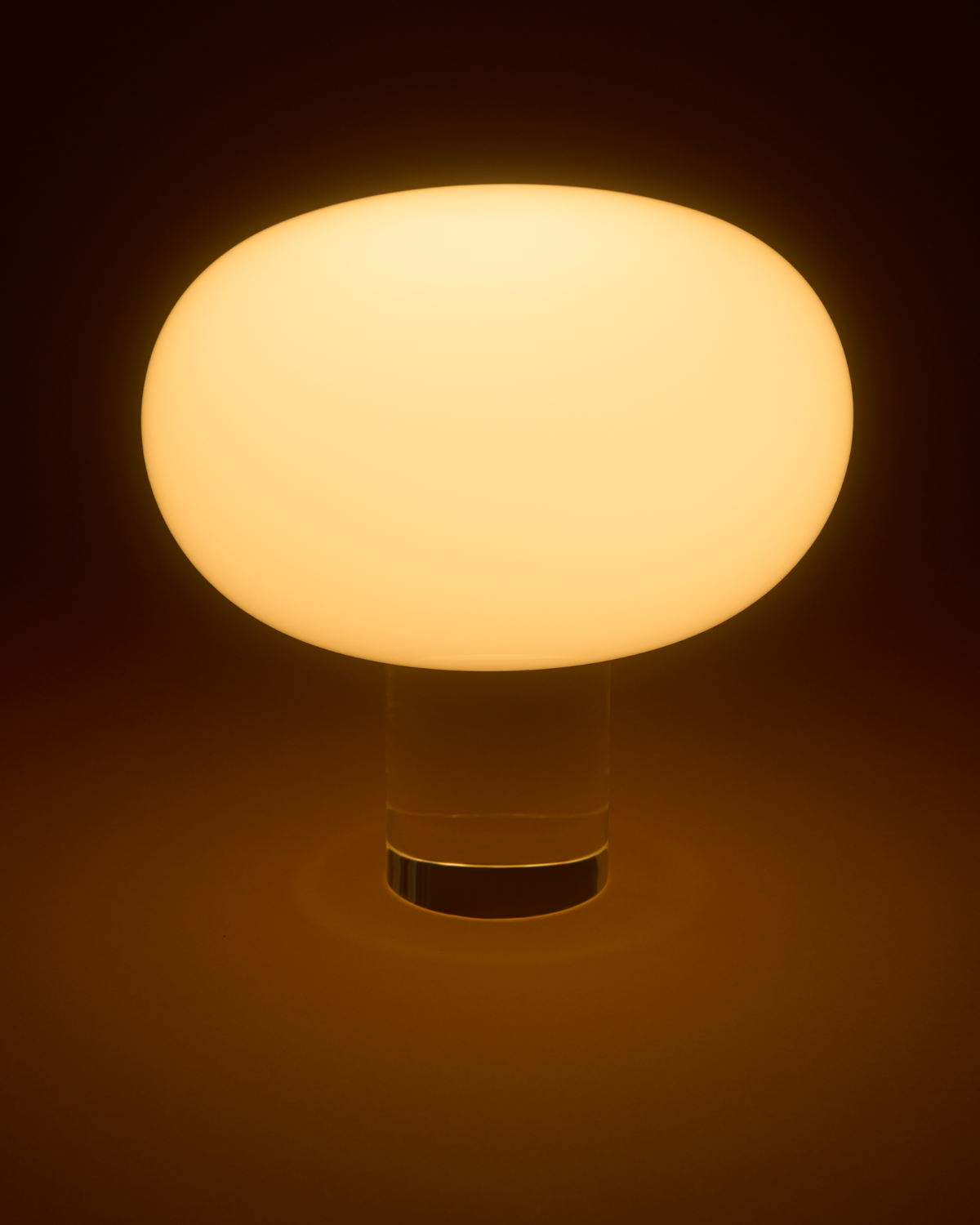 Round light bulb with a warm glow on a dark background
