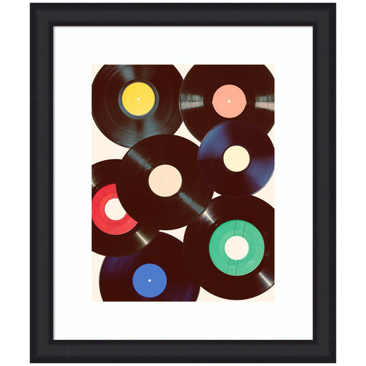 Framed artwork of vinyl records with colorful labels on a white background