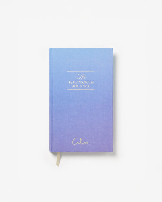 Gradient blue and purple journal with 'The Five Minute Journal' text on a white background