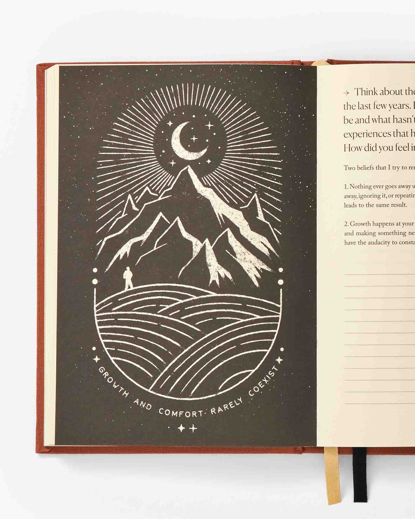 Open book with a mountain and moon illustration on a white background