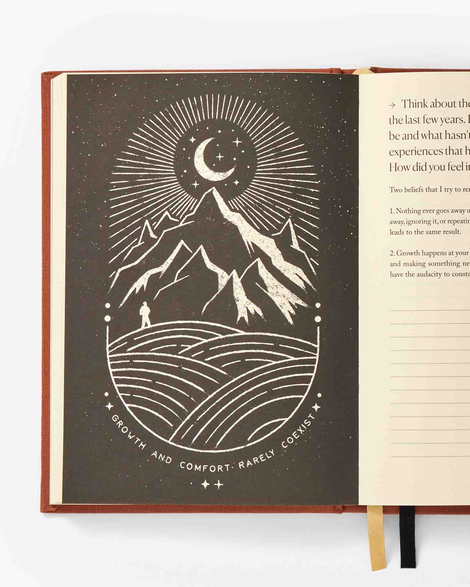 Open book with a mountain and moon illustration on a white background