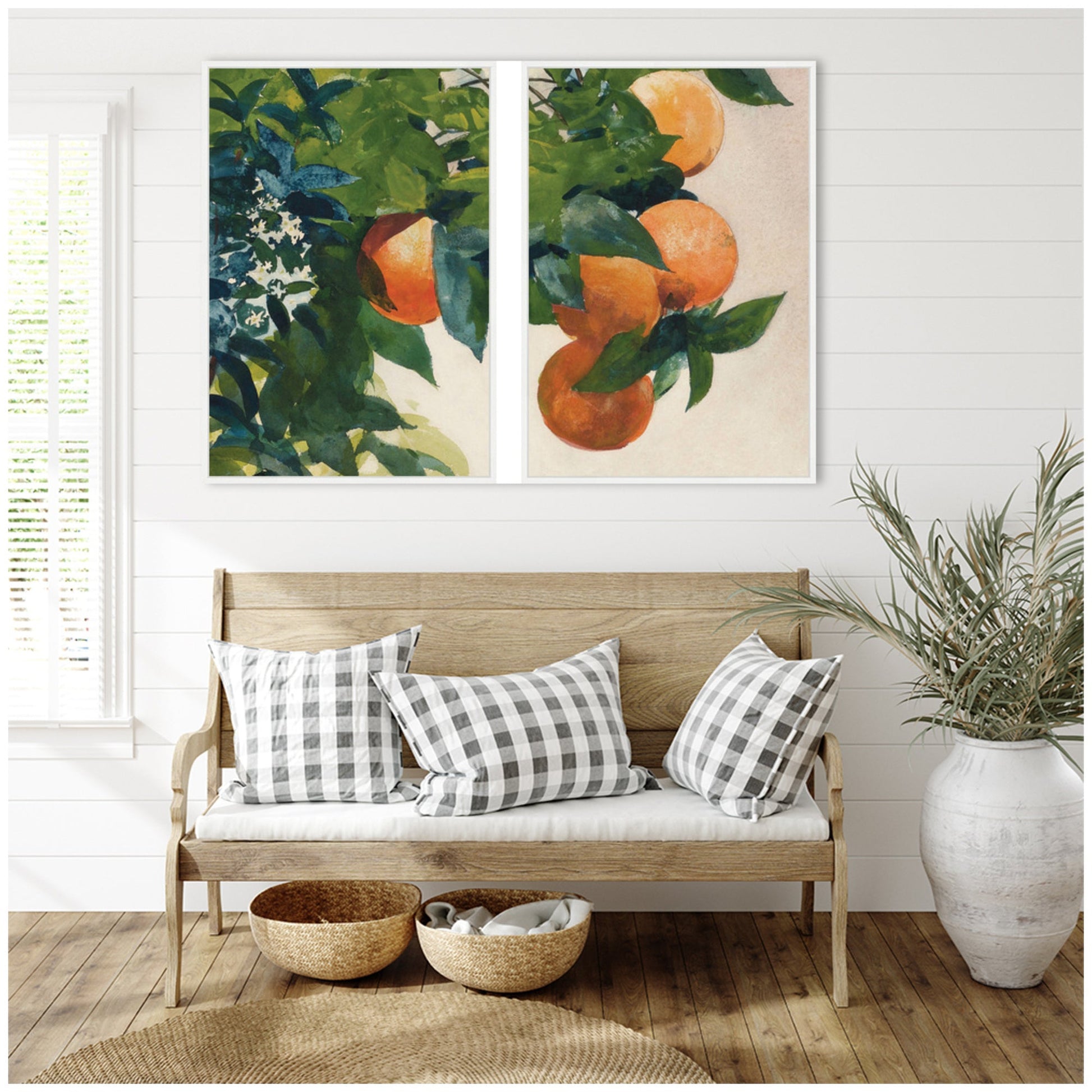 Wooden bench with checkered pillows, woven baskets, and a plant in a room with wall art of oranges and leaves.