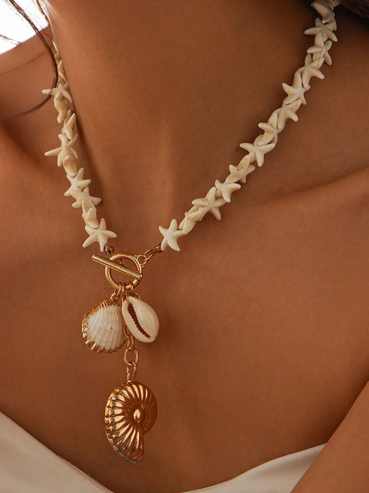 Necklace with starfish beads and shell charms on a person's neck