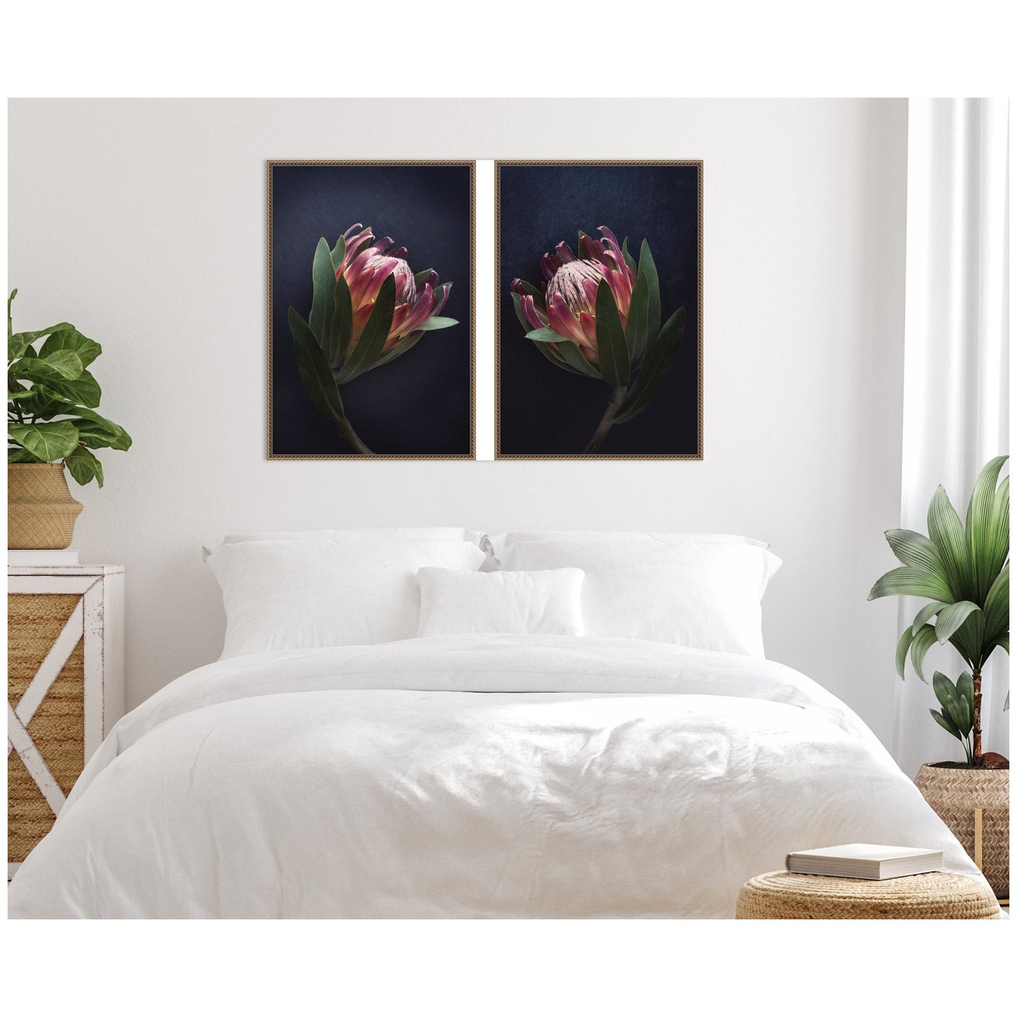 Two framed flower prints above a bed in a bedroom setting.