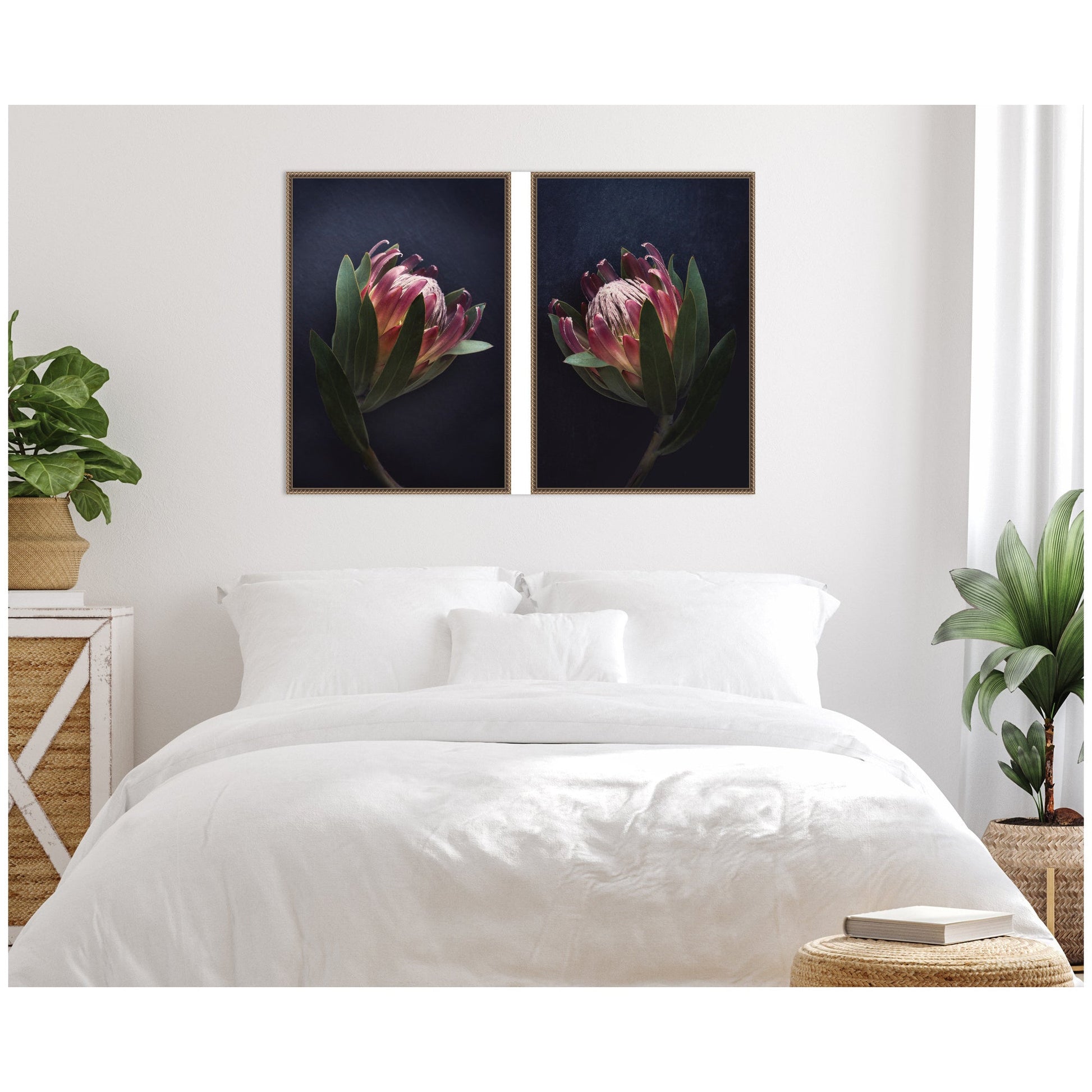 Two framed flower prints above a bed in a bedroom setting.