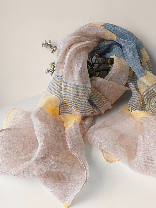 Colorful scarf with pink, yellow, and blue patterns on a white background