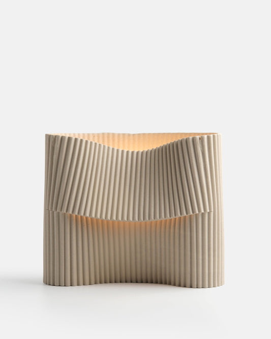 Beige pleated clutch bag on a light gray background