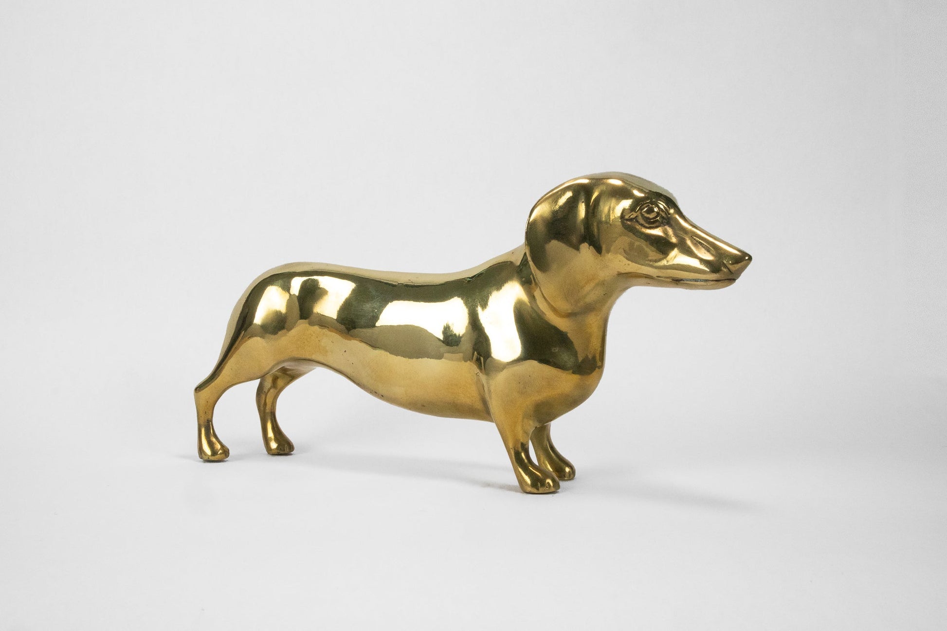 Gold dog-shaped object on a white background
