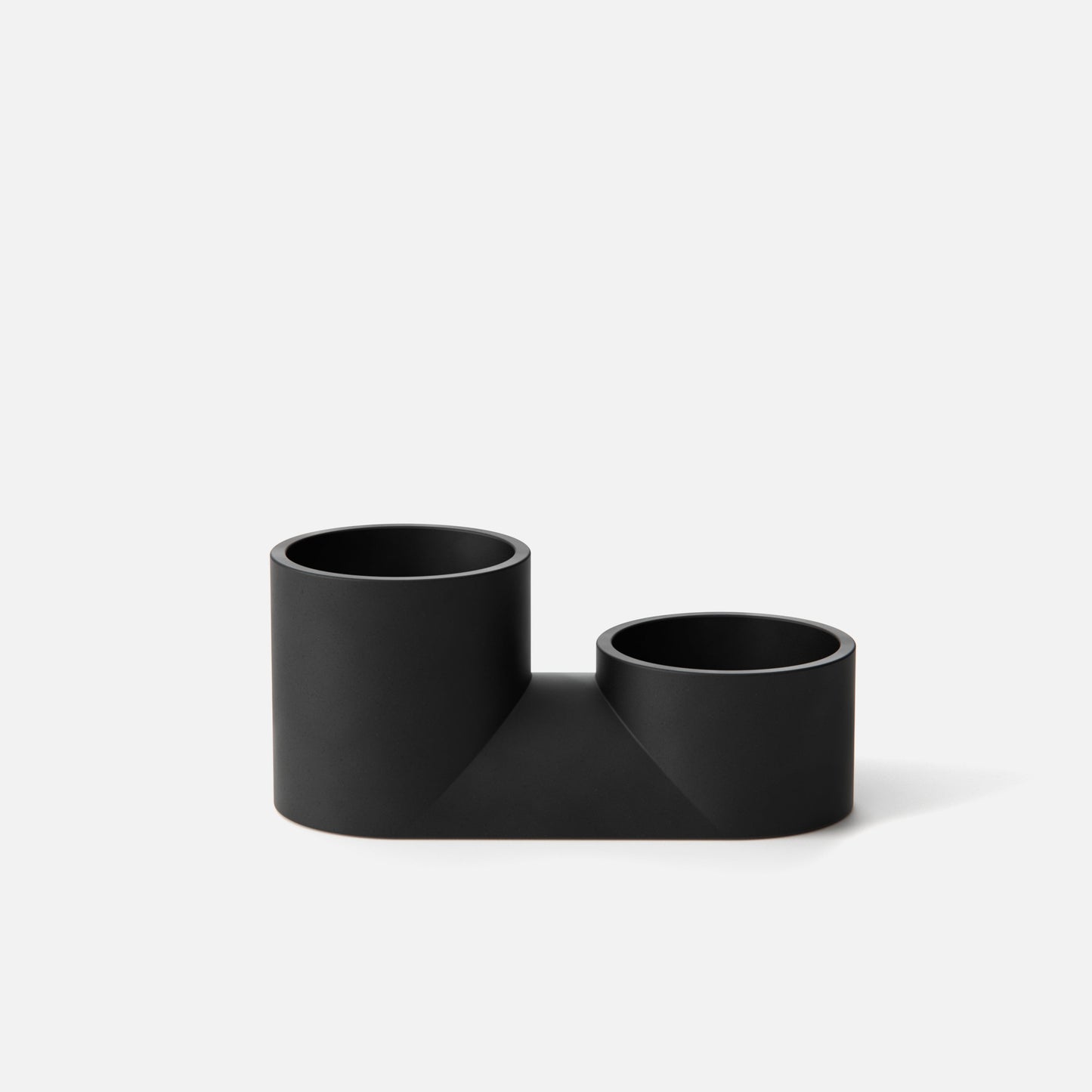 Black L-shaped pipe connector on a white background