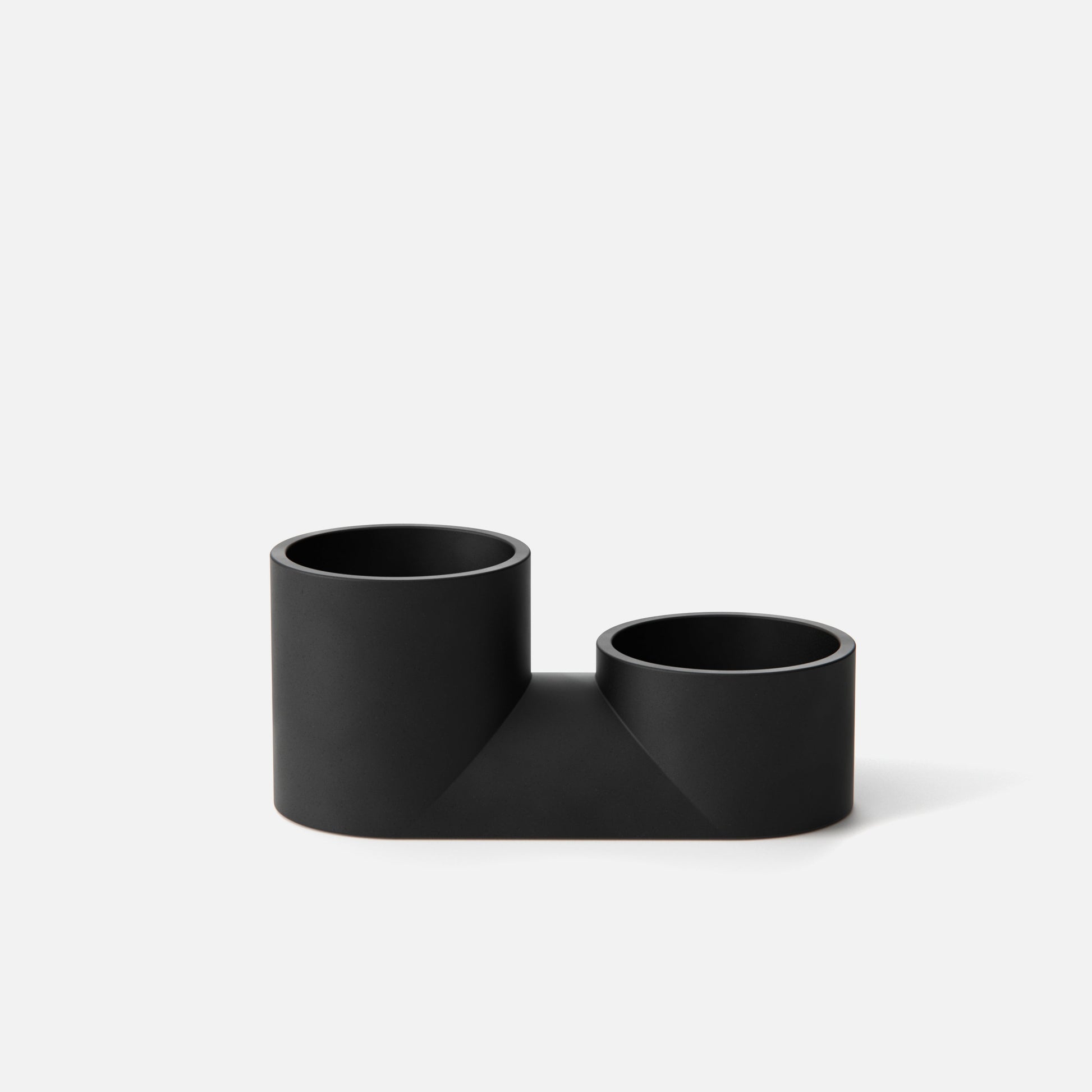 Black L-shaped pipe connector on a white background