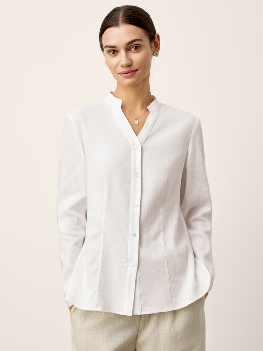 Woman wearing a white blouse against a light background
