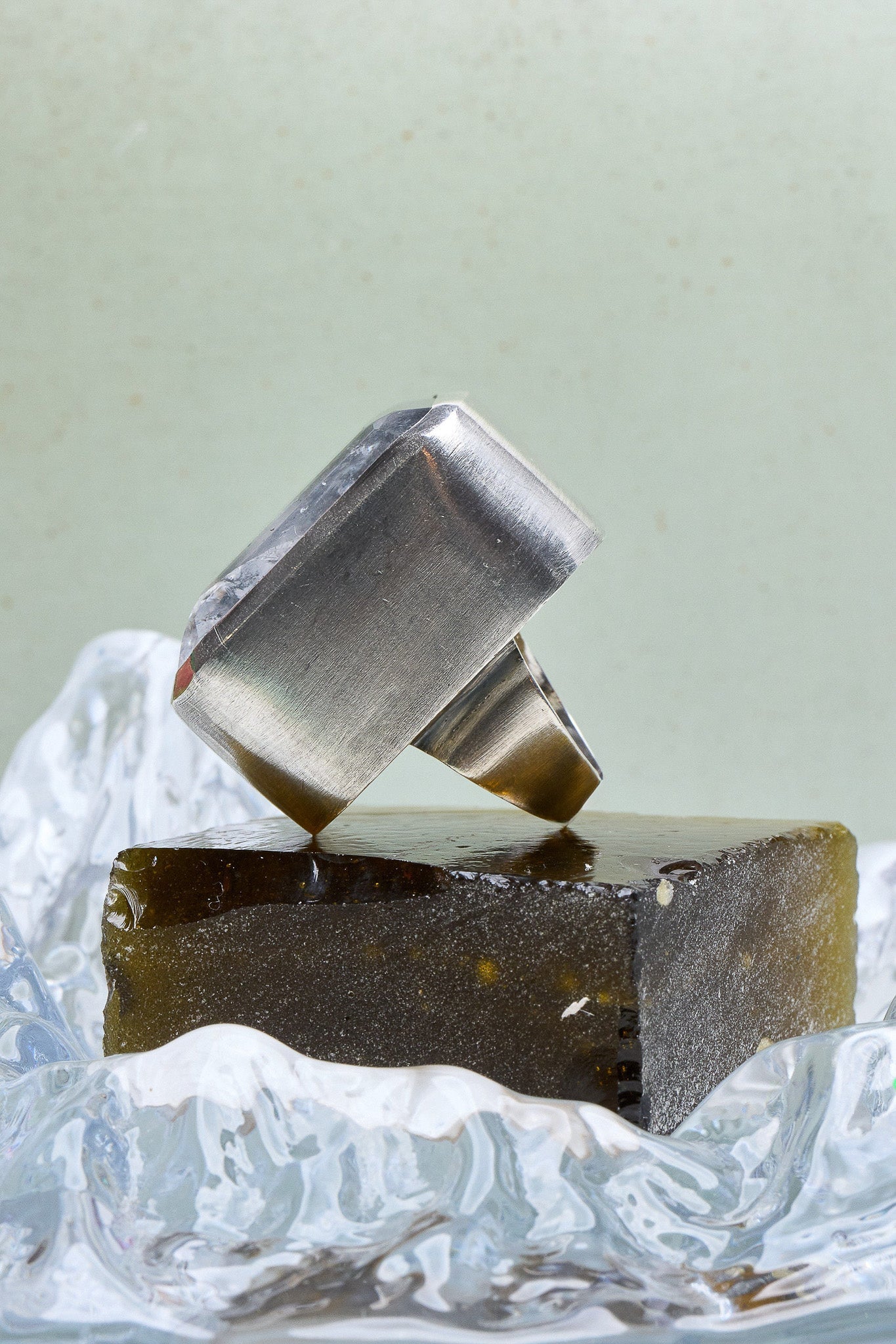 Two metallic rings stacked on top of each other with a textured surface in the foreground.