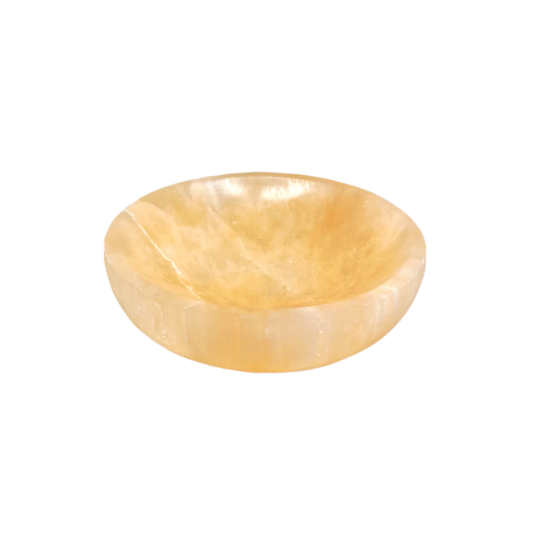 Round, polished stone bowl on a white background