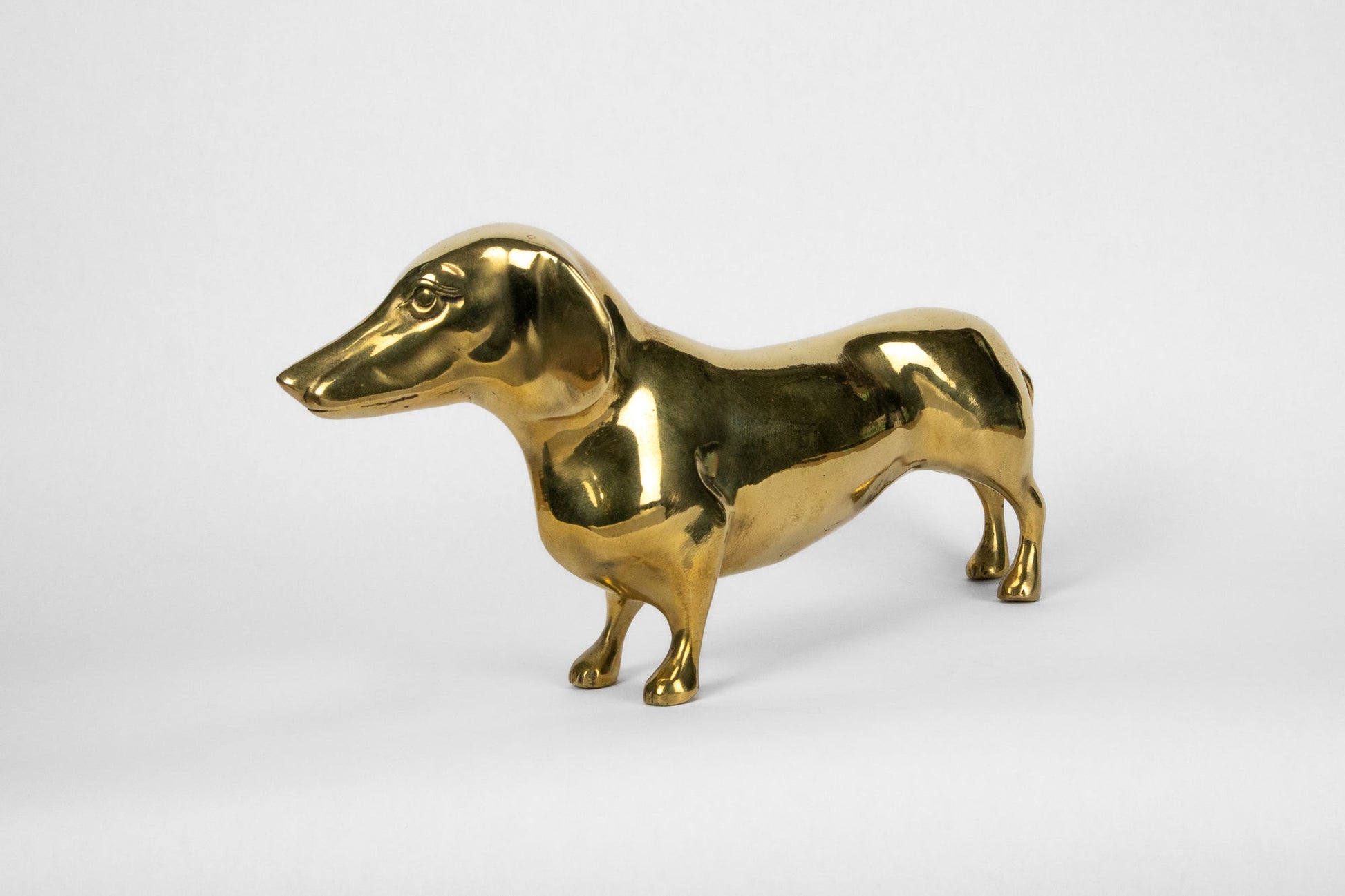Gold dog-shaped figurine on a white background
