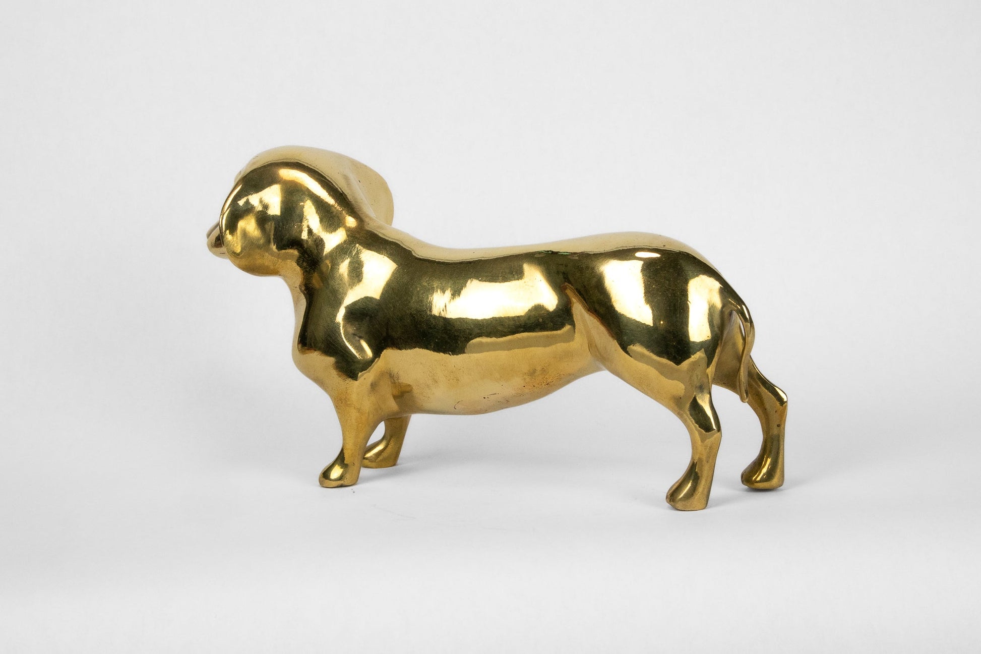 Gold dog-shaped object on a white background