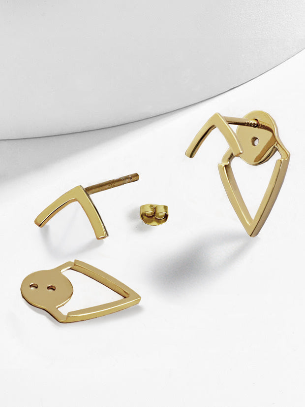 Gold abstract earrings on a white background