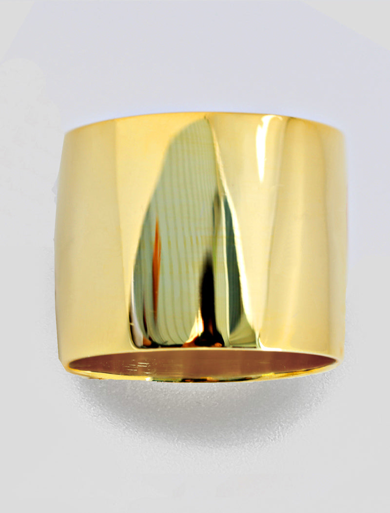 Gold cylindrical object on a light gray background