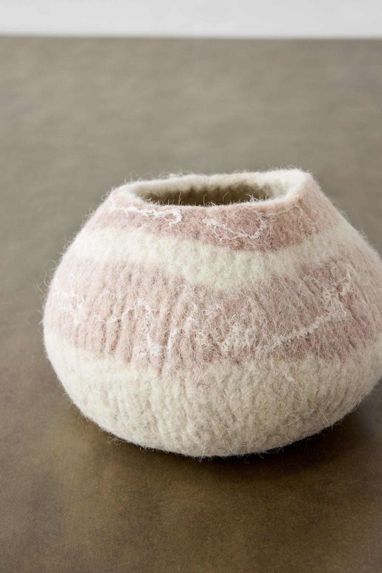 Textured ceramic vase on a neutral background