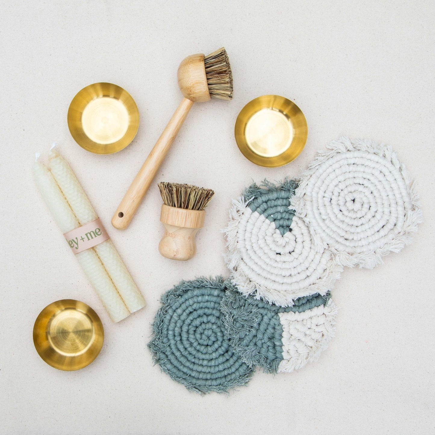 Cleaning tools including brushes and cloths on a light background