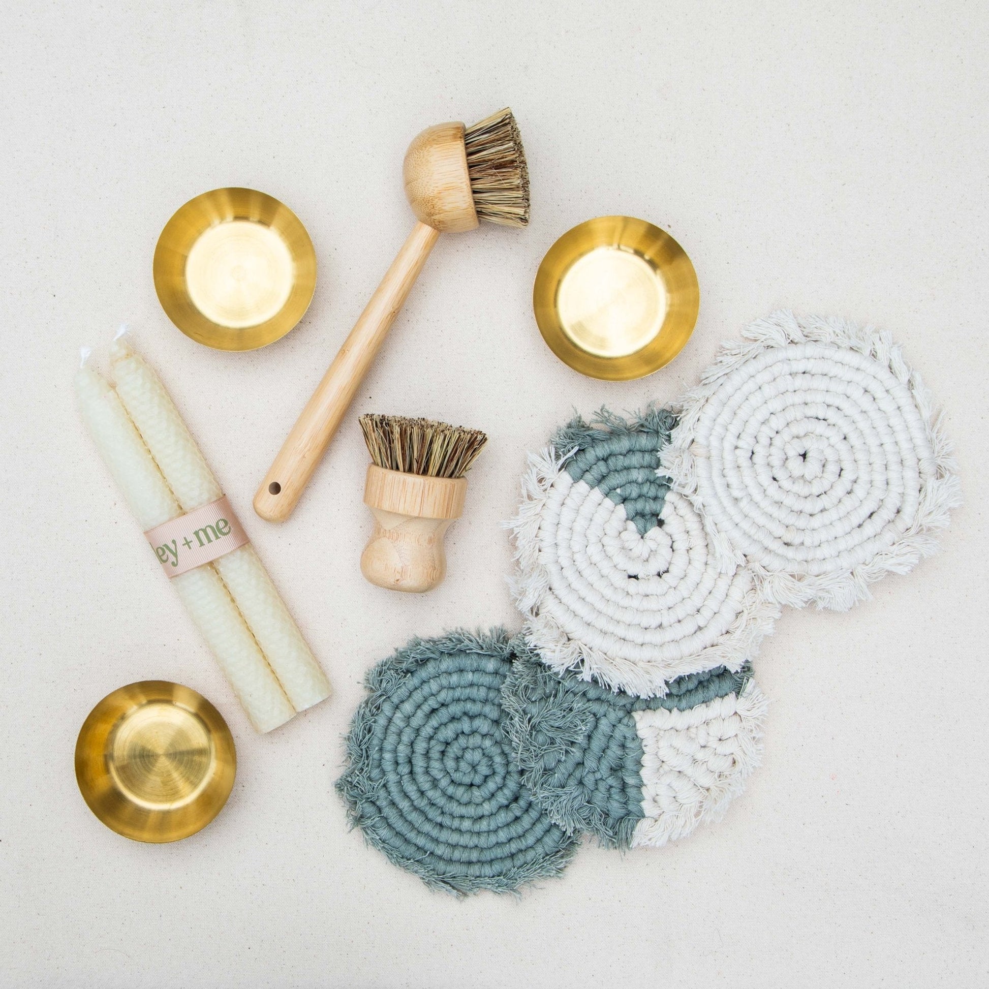 Cleaning tools including brushes and cloths on a light background