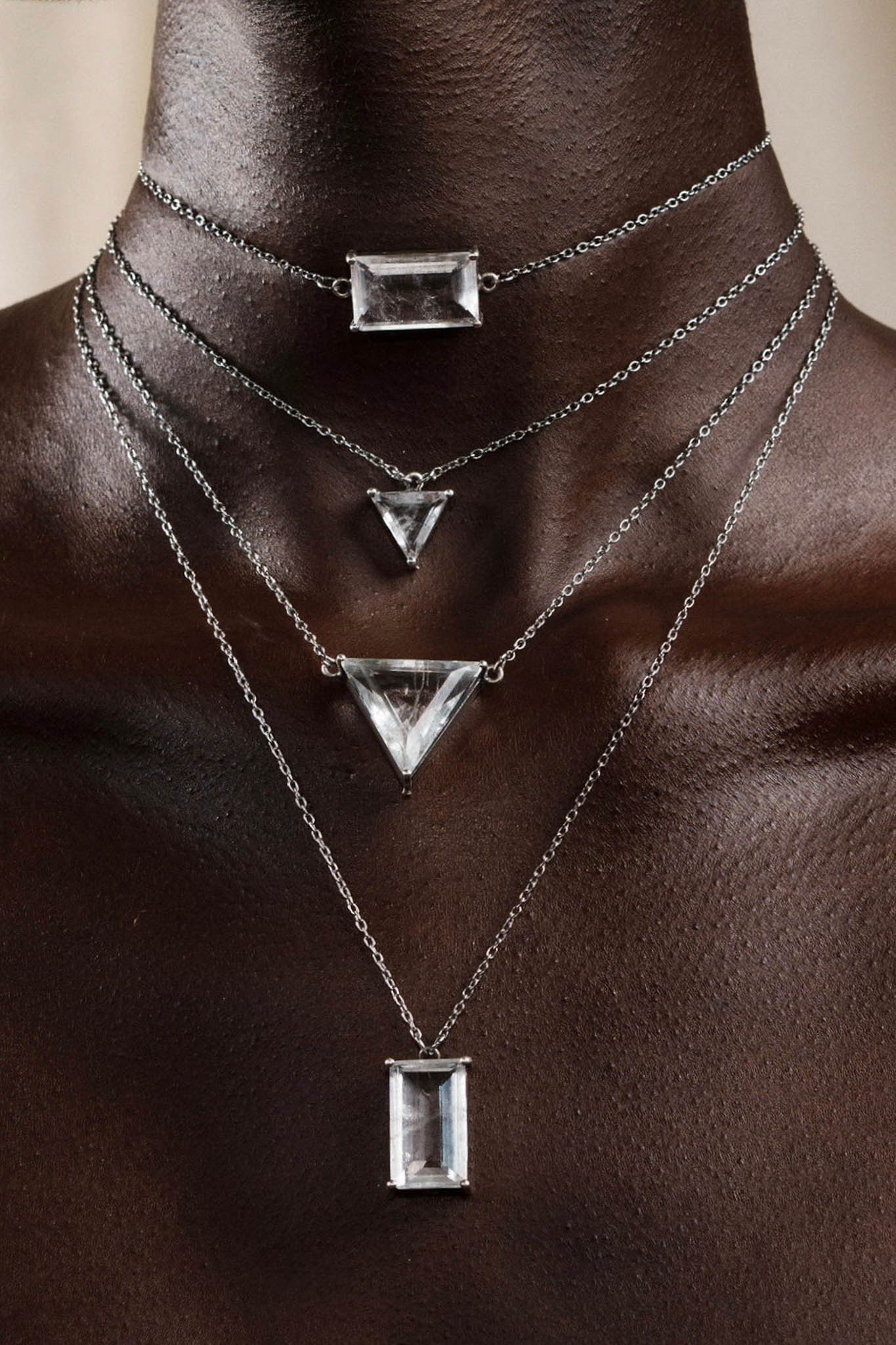 Necklace with geometric pendants on a person's neck