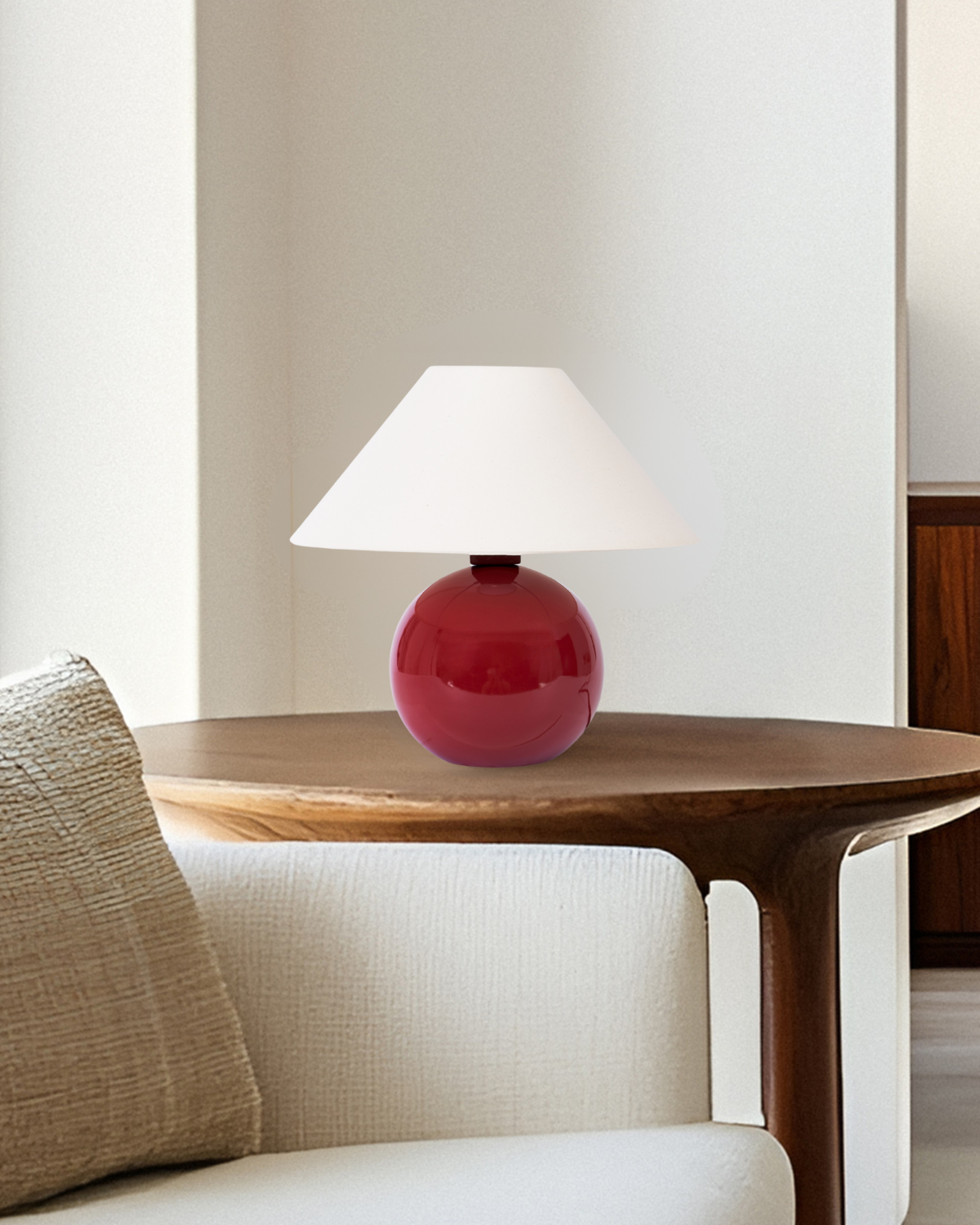 Red lamp on a wooden table next to a white sofa