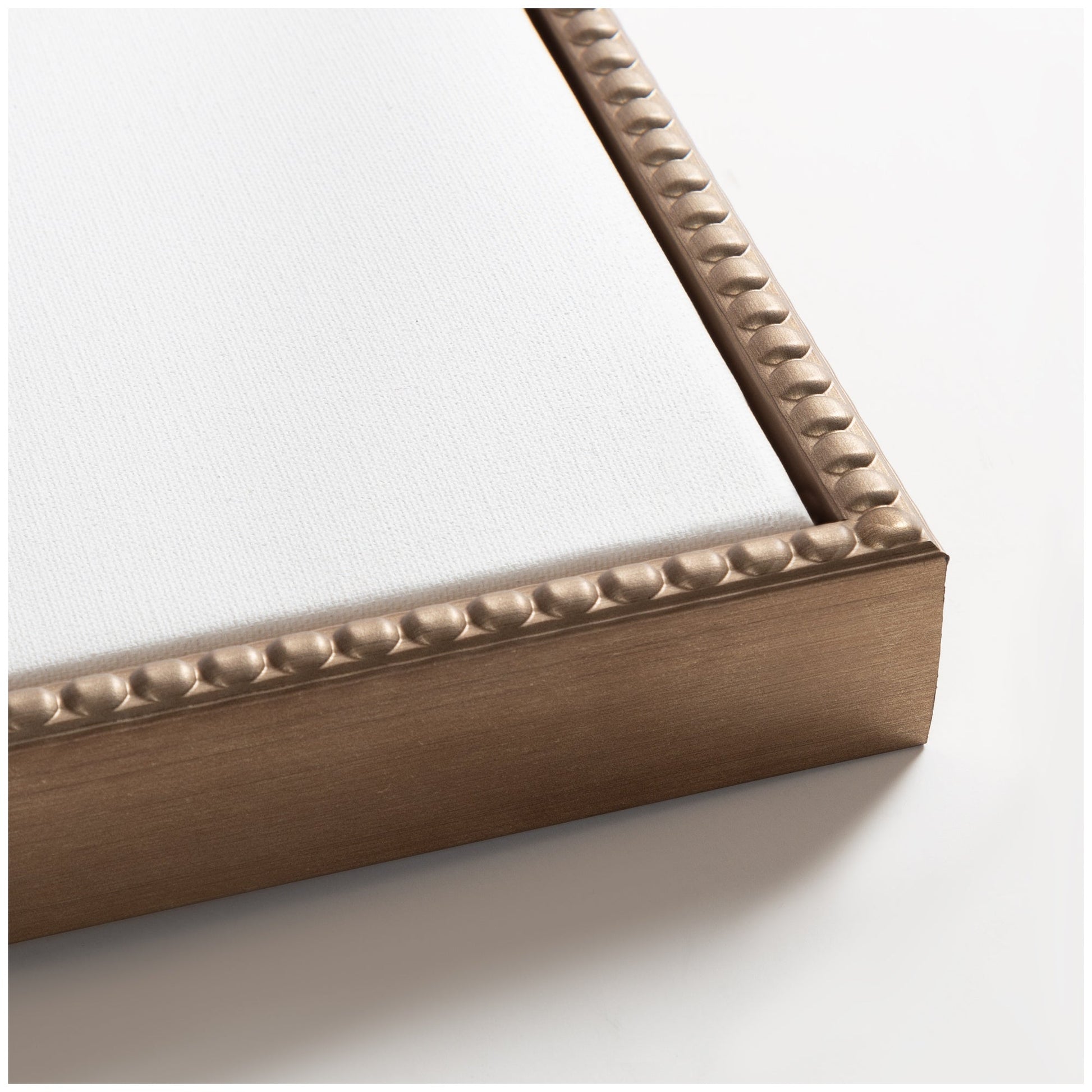 Close-up of a bronze picture frame corner on a white background