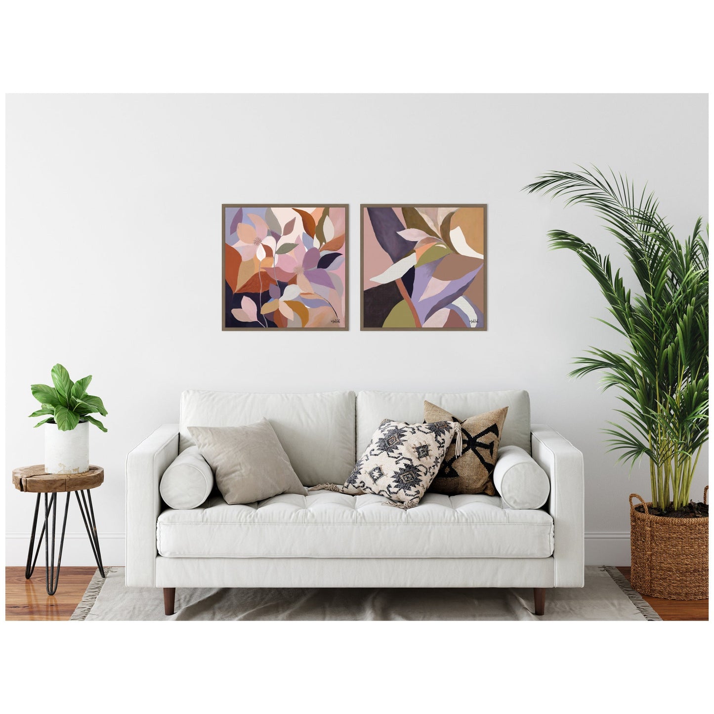 Living room with a white sofa, decorative pillows, and abstract wall art.