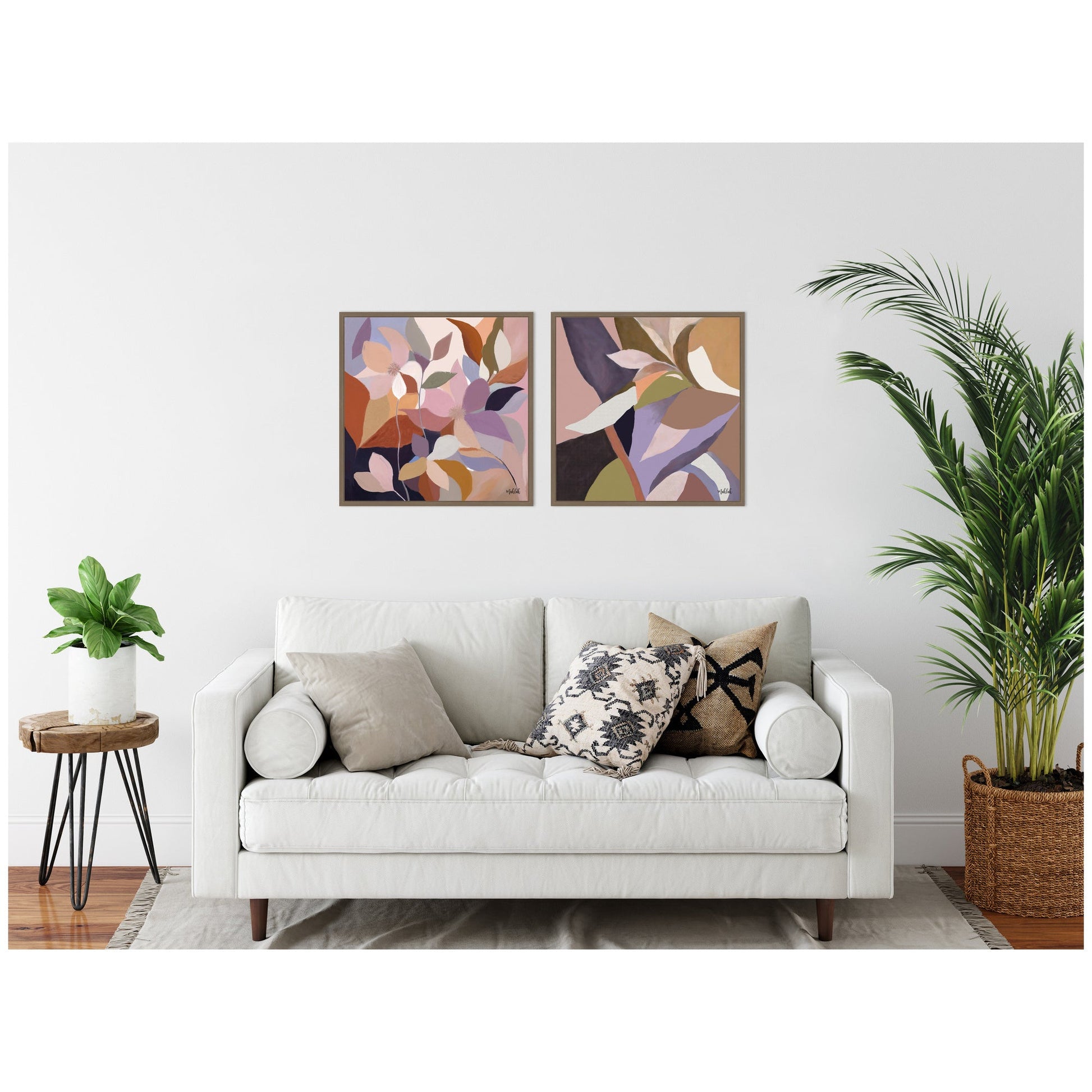 Living room with a white sofa, decorative pillows, and abstract wall art.