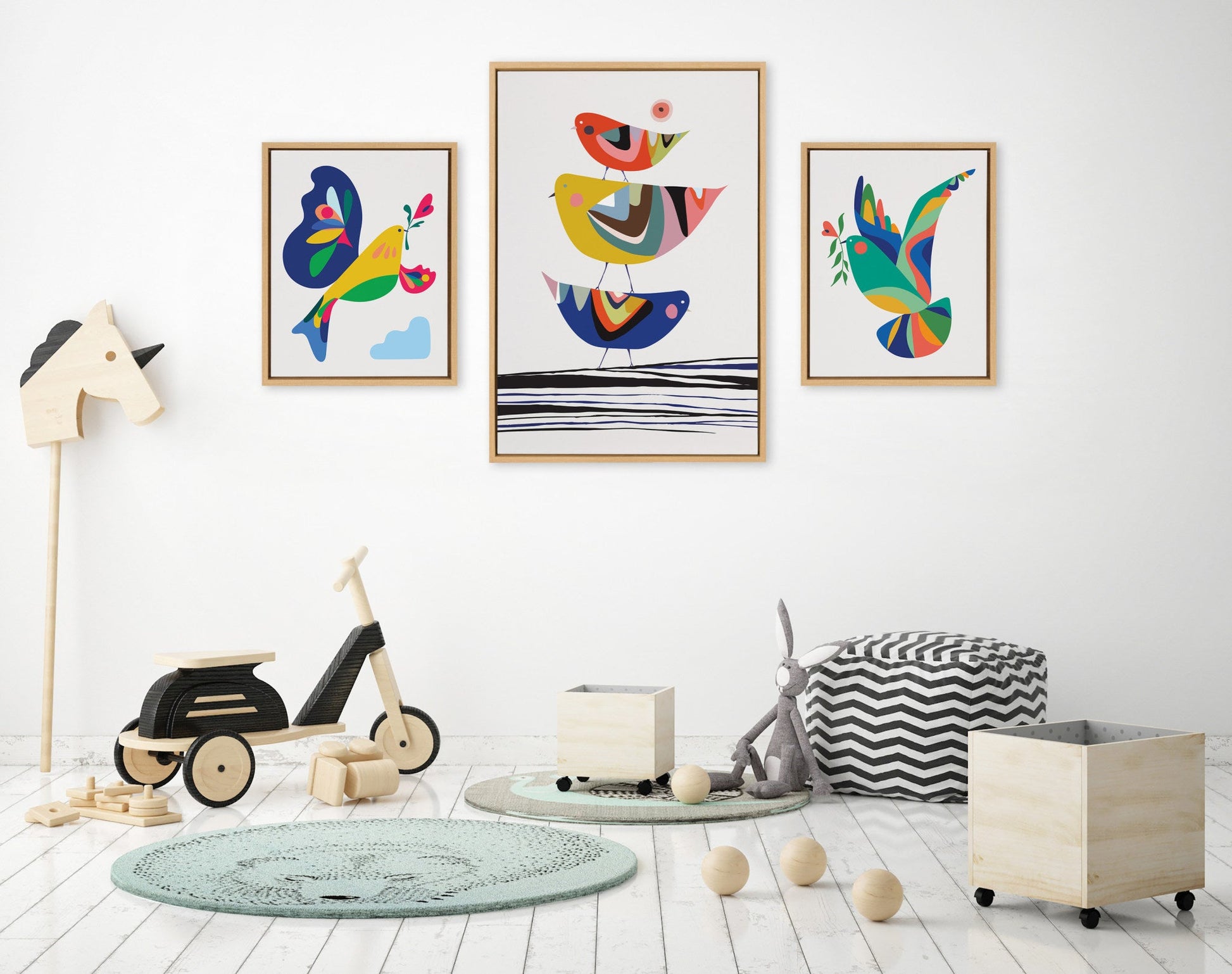 Children's room with colorful wall art, toys, and furniture on a white floor.