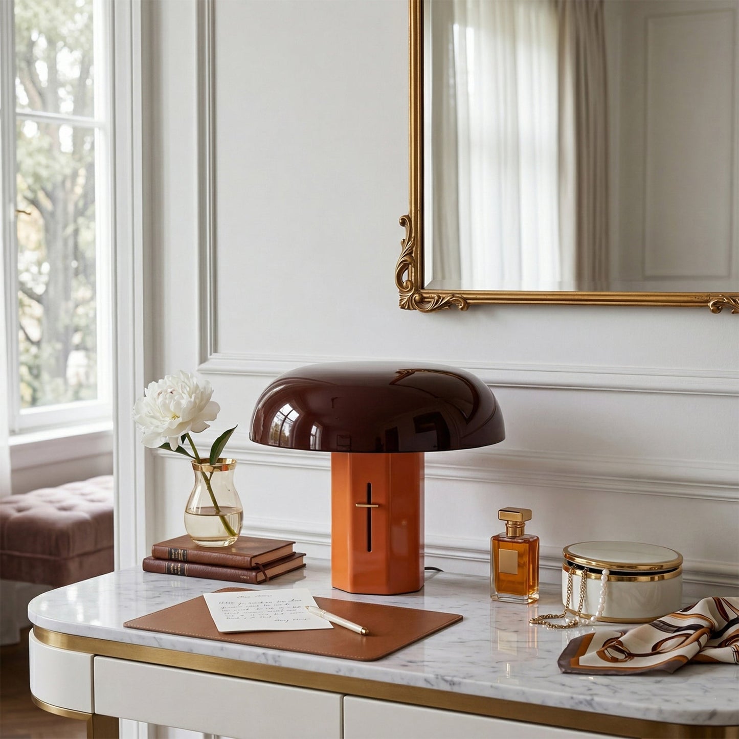 Decorative table with lamp, books, and other items in a stylish interior setting.