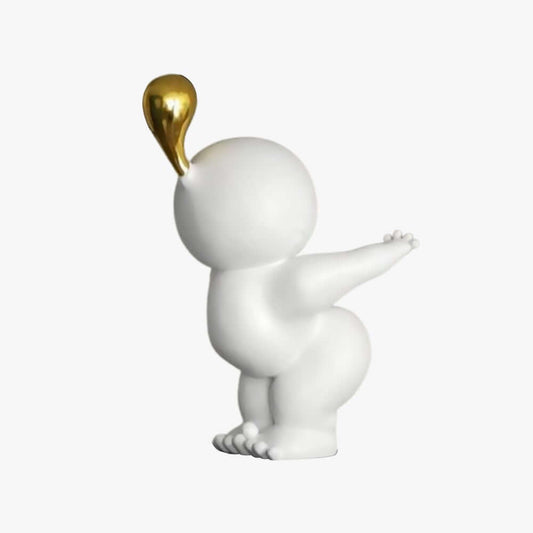 White figurine with a gold teardrop on a white background