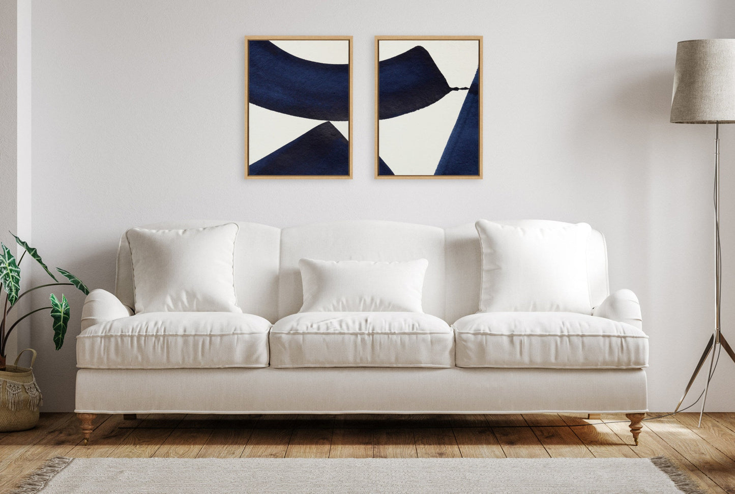 White sofa in a living room with abstract art on the wall
