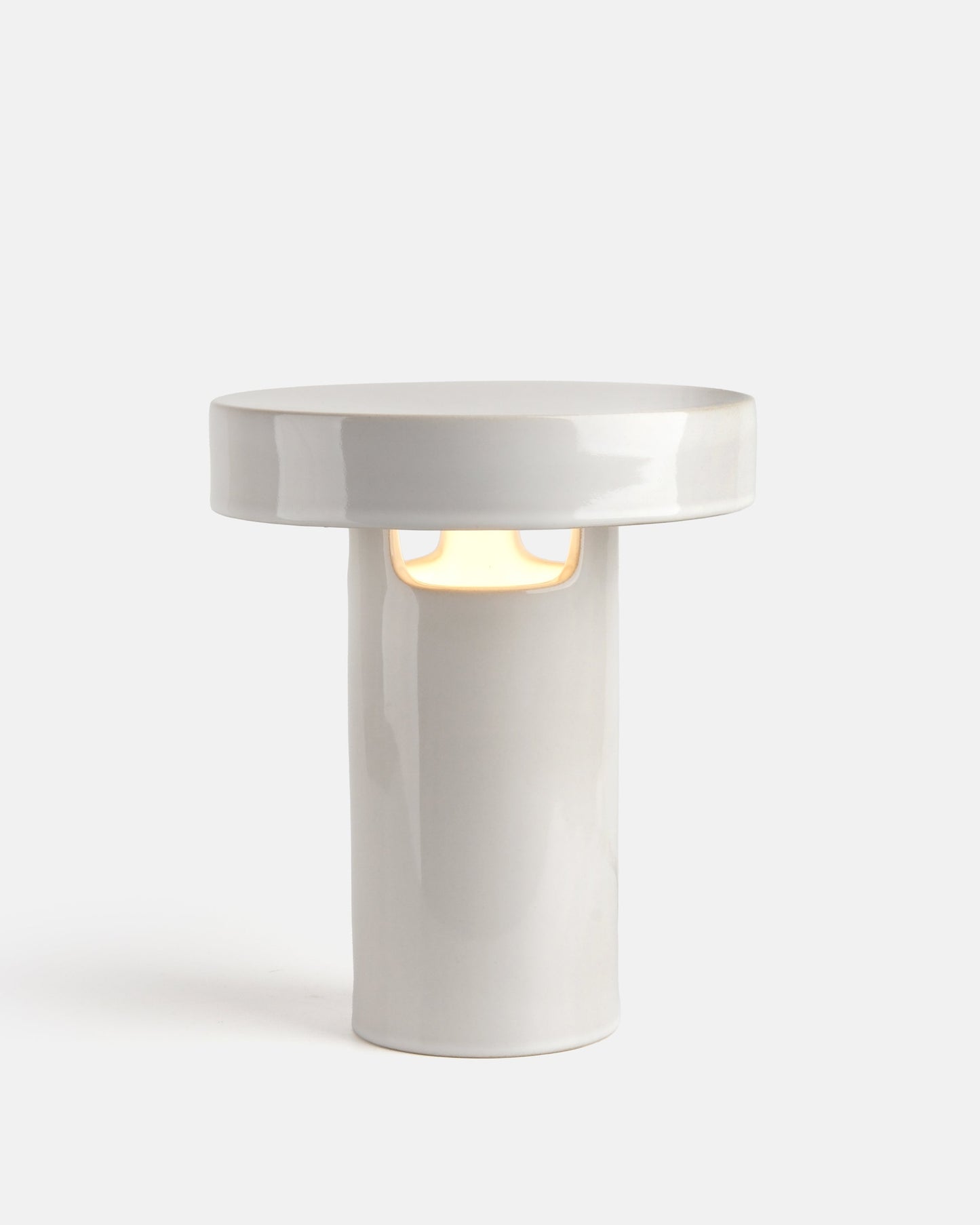 White cylindrical lamp with a round top on a white background