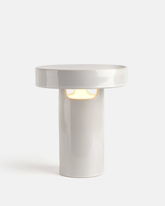 White cylindrical lamp with a round top on a white background